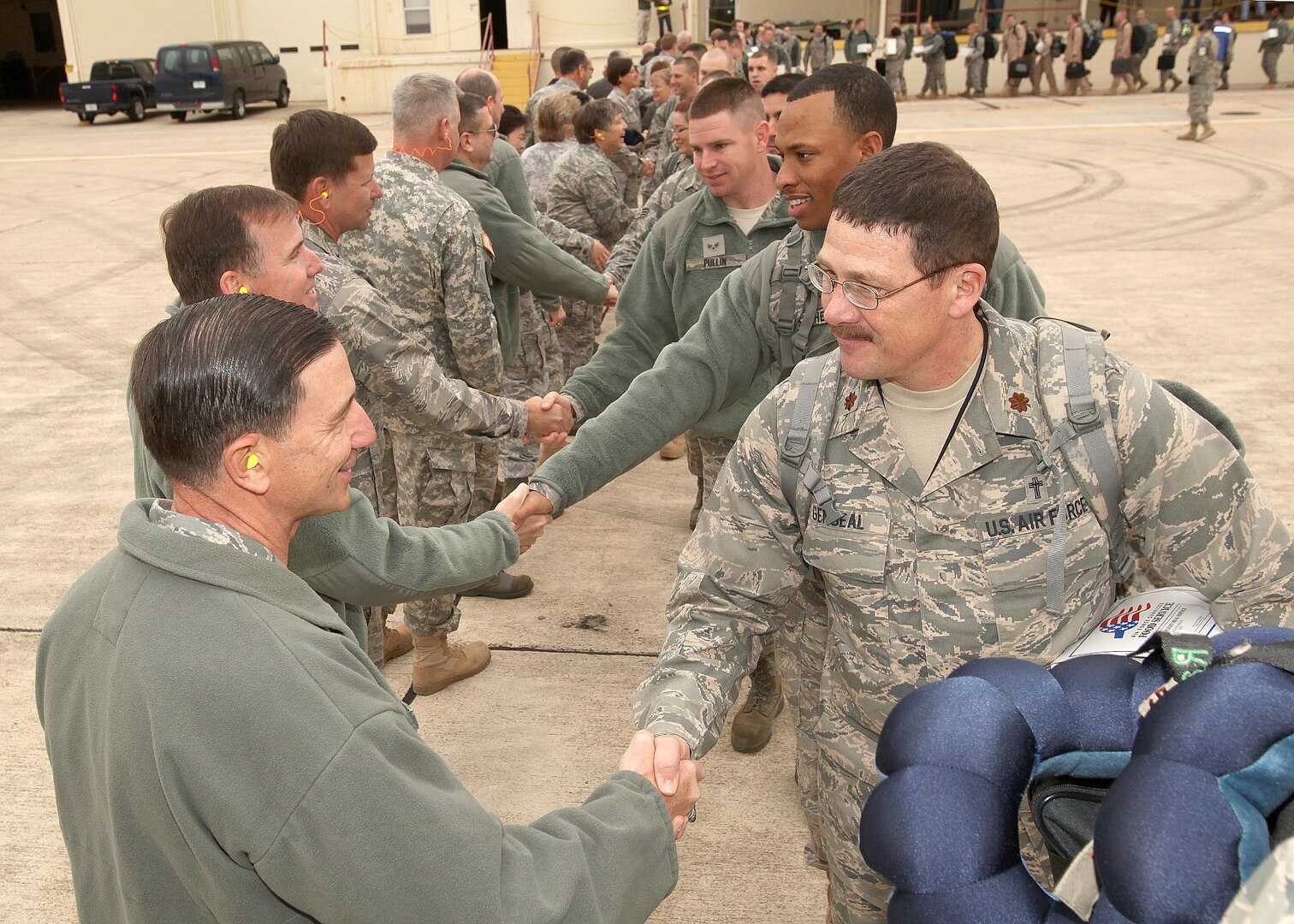 Joint Base San Antonio leaders bid farewell to Airmen as they board a plane at Lackland Air Force Base Jan. 3. Airmen from Lackland and Randolph AFBs are among nearly 130 Airmen deploying to Kuwait, Qatar and additional locations in Southwest Asia in support of Operation New Dawn. (U.S. Air Force photo/Robbin Cresswell)  