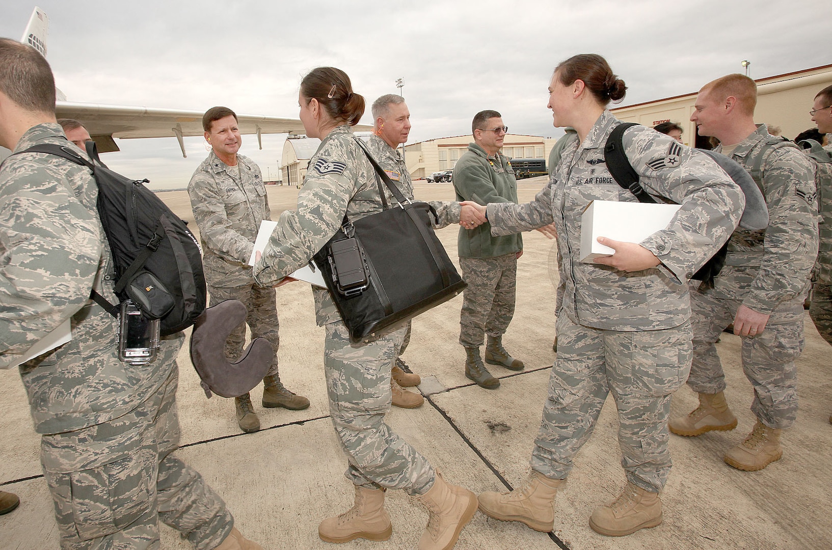 Joint Base San Antonio leaders bid farewell to Airmen as they board a plane at Lackland Air Force Base Jan. 3. Airmen from Lackland and Randolph AFBs are among nearly 130 Airmen deploying to Kuwait, Qatar and additional locations in Southwest Asia in support of Operation New Dawn. (U.S. Air Force photo/Robbin Cresswell)  