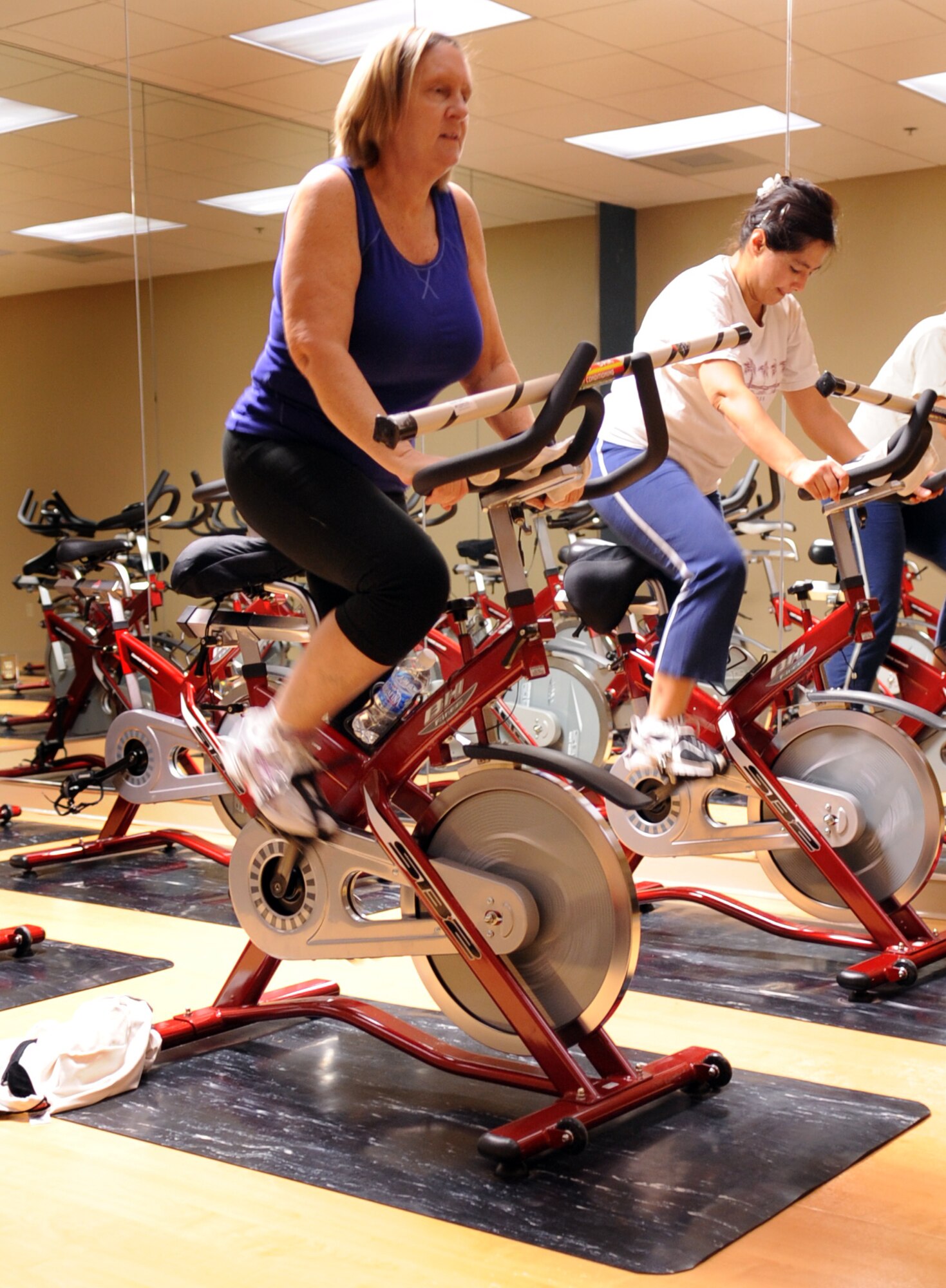 MOODY AIR FORCE BASE, Ga. -- Debbie McDaniel and Kristy Edmondson, military spouses, attend a spin class in the new Aerobics Center Jan. 7. The Aerobics Center has new training equipment, including spin bikes and weights. (U.S. Air Force photo/Airman 1st Class Douglas Ellis)(RELEASED)
