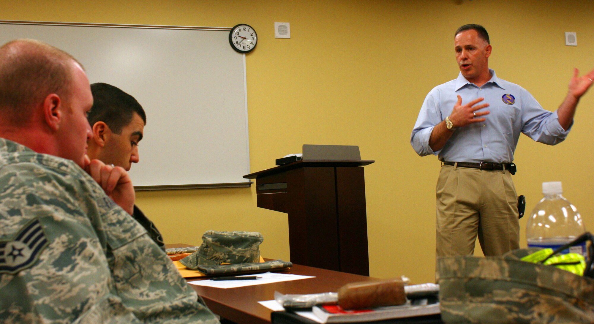 310th Space Wing Command Chief Master Sgt. Rocky Hart, right, talks readiness to deploying members of the 710th Security Forces Squadron during the Yellow Ribbon Lite program at the 310th MSG/AMDF Building at Buckley Air Force Base, Colo. The condensed alternative to the standard Yellow Ribbon event help to prepare the 10 Airmen for their deployment in January.
