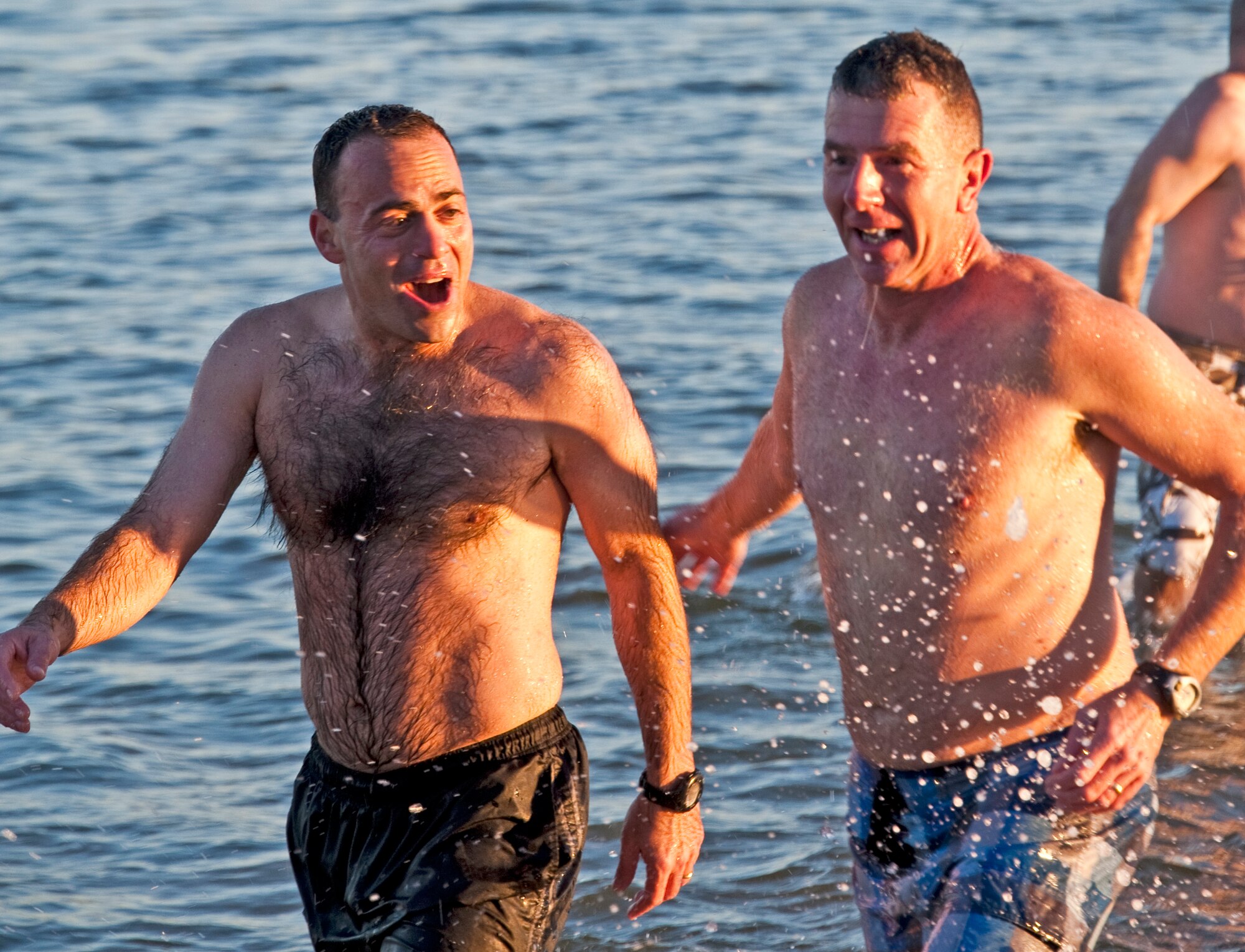 Col. Sal Nodjomian, 96th Air Base Wing commander and Chief Master Sgt. Tom Westermeyer, command chief, return to land after taking part in Eglin’s first-ever Polar Bear swim, held at Post’l Point, Jan. 7.  More than 100 braved the 34 degree temperatures and waded into Choctawhatchee Bay, including the Marine Fighter Attack Training Squadron 501 and members of the Coast Guard Station Destin.  (U.S. Air Force photo/Samuel King Jr.)