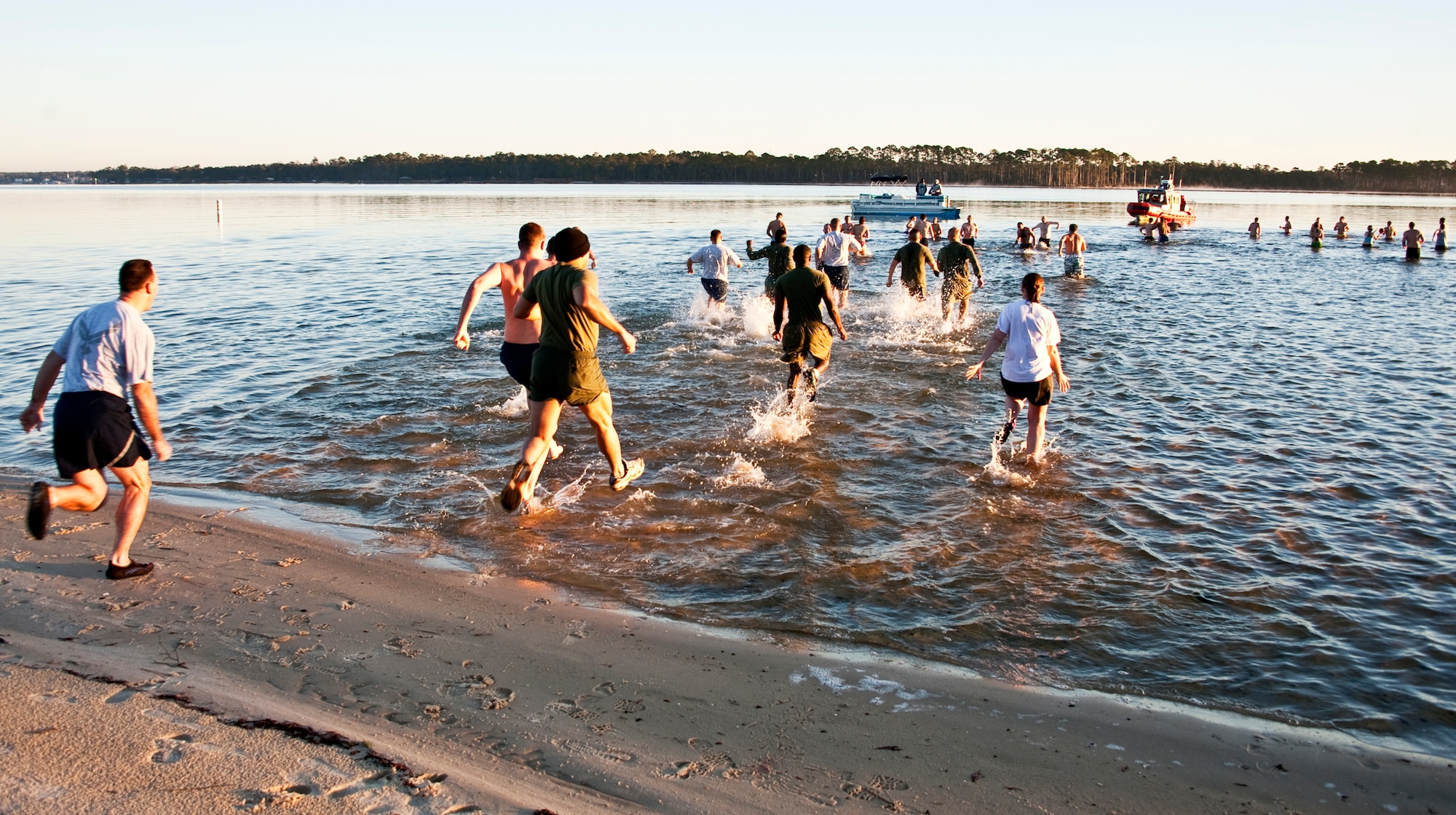 Team Eglin members rush into the chilly waters of Choctawhatchee Bay during Eglin’s first-ever Polar Bear swim, held at Post’l Point, Jan. 7.  More than 100 braved the 34 degree temperatures and took a dip including the 96th Air Base Wing commander and command chief.  (U.S. Air Force photo/Samuel King Jr.)