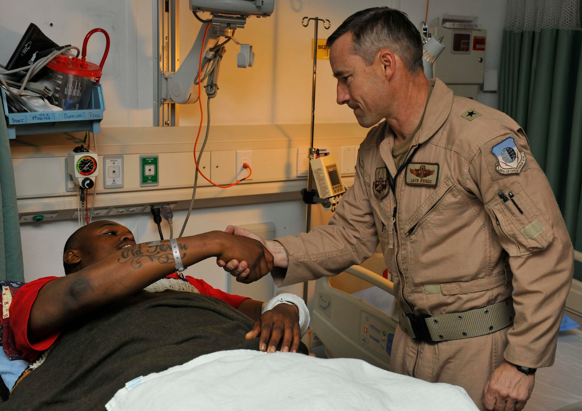 Senior Airman Darius Webb, 325th Communications Squadron radio frequency transmission systems technician, is awarded the Purple Heart by Brigadier Gen. Jack Briggs, 455th Air Expeditionary Wing commander at the Bagram Airfield hospital. (U.S. Air Force courtesy photo)