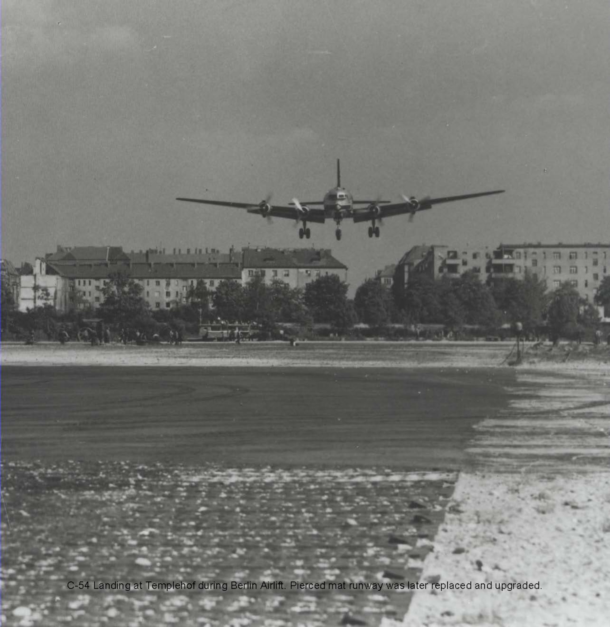 C-54 Landing at Templehof during Berlin Airlift.  Pierced steel runway matting could not stand up to the heavy usage and an improved runway had to be built.