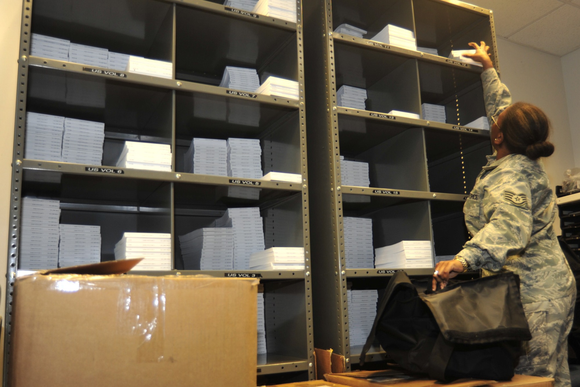 Staff Sgt. Anita Self, 62nd Operations Support Squadron combat crew communication supervisor, gathers flight information publications and prepares a communication kit Jan. 5 at McChord Field, Joint Base Lewis-McChord, Wash. Before a flight, crews are equipped with communication kits and briefed on proper in-flight operation security procedures.  (U.S. Air Force photo/Airman Leah Young)
