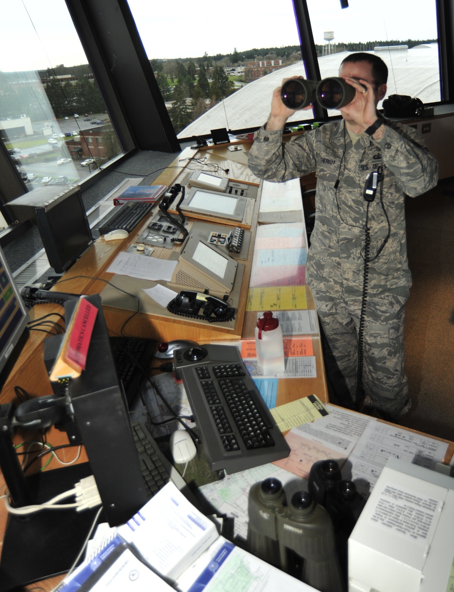 Staff Sgt. Justin Theriot, 62nd Operations Support Squadron air traffic control technician, observes an incoming aircraft from the air traffic control tower Jan. 5 at McChord Field, Joint Base Lewis-McChord, Wash. The air traffic control flight is responsible for monitoring the runway and air space within a five-mile radius of McChord Field. (U.S. Air Force photo/Airman Leah Young)