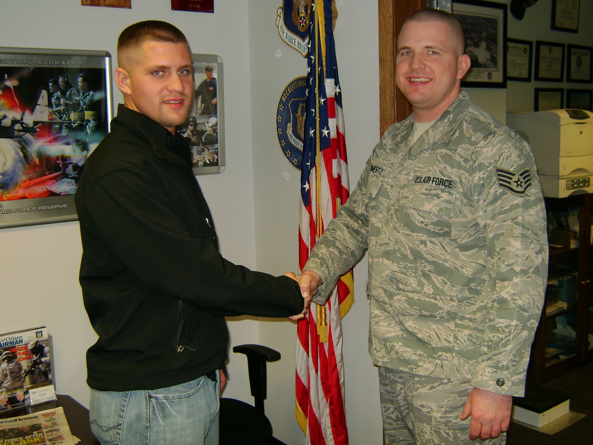Brothers in Arms: Kurt Mommertz and his older brother, 914th Airlift Wing Recruiter Staff Sgt. Micheal Mommertz shake hands after Kurt’s enlistment into the United States Air Force Reserve January 6 2011.  Sergeant Mommertz recruited his brother to join the 914th Airlift Wing as a fire fighter.