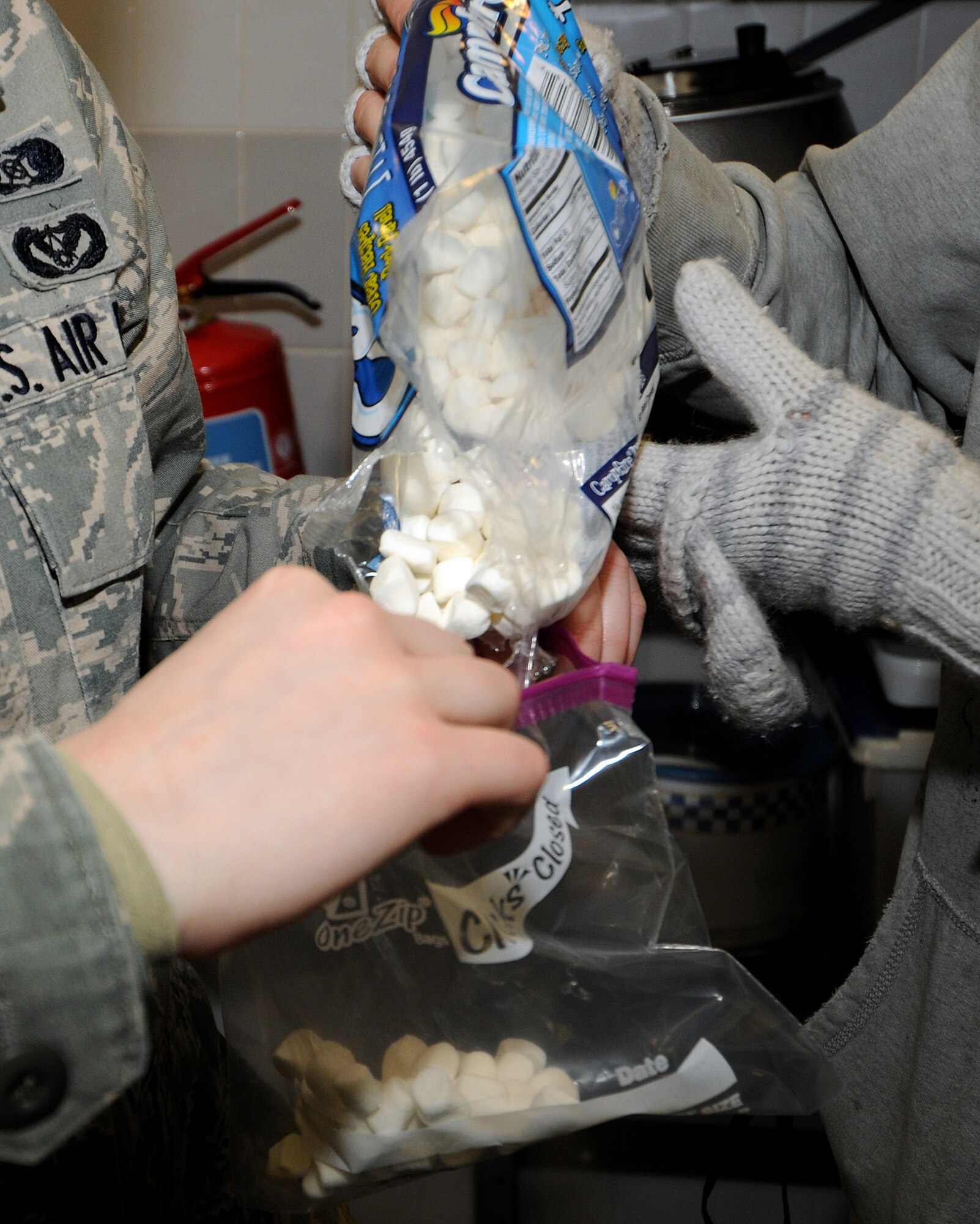 RRAF MILDENHALL, England -- Airmen from across RAF Mildenhall band together to prepare hot chocolate for base security forces members working the gates here Jan. 7, 2011.  Participants met at The Loft, a chapel sponsored day room, made hot chocolate and goodie bags, and passed them out to all 100th Security Forces Squadron personnel controlling entry at the gates.  (U.S. Air Force photo/Senior Airman Tabitha M. Lee)  
