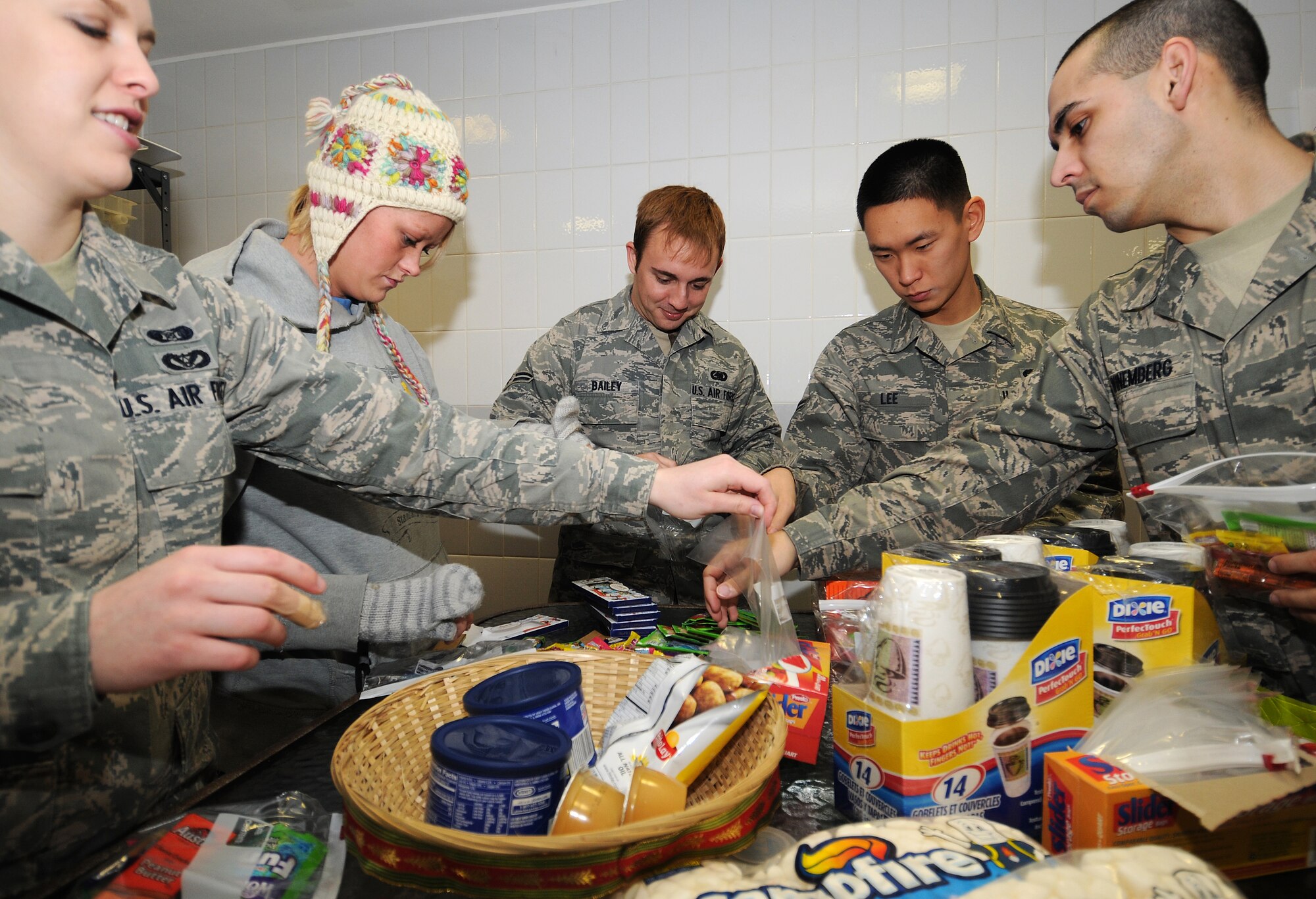RAF MILDENHALL, England -- Airmen from across RAF Mildenhall band together to prepare hot chocolate for base security forces working the gates here Jan. 7, 2011.  Participants met at The Loft, a chapel sponsored day room, made hot chocolate and goodie bags, and passed them out to all 100th Security Forces Squadron personnel controlling entry at the gates. (U.S. Air Force photo/Senior Airman Tabitha M. Lee)   