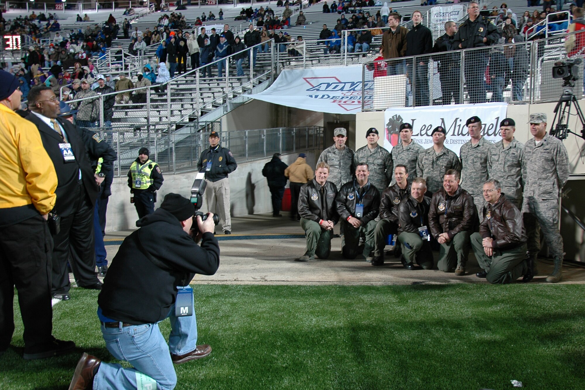 Shreveport Mayor Cedric Glover, (2nd from left) looks on as the members of the flyover team pose for a group photo at the Advocare V 100 Independence Bowl in Shreveport, La., Dec. 27, 2010. A B-52 Stratofortress from the 917th Wing’s 93rd Bomb Squadron at Barksdale Air Force Base, La., performed the flyover for the crowd before the kickoff of the game. The jet was flown by a Total Force crew of Regular Air Force members from the 2nd Bomb Wing's 11th Bomb Squadron and Air Force Reserve members from 93rd BS. Joint Terminal Attack Controllers from the 122nd Air Support Operations Squadron and Det 1 20th Air Support Operations help facilitate the event. The U.S. Air Force Academy Falcons defeated the Georgia Tech Yellow Jackets in the Independence Bowl 14-7. (U.S. Air Force photo/ Senior Airman Kimberly Simon)