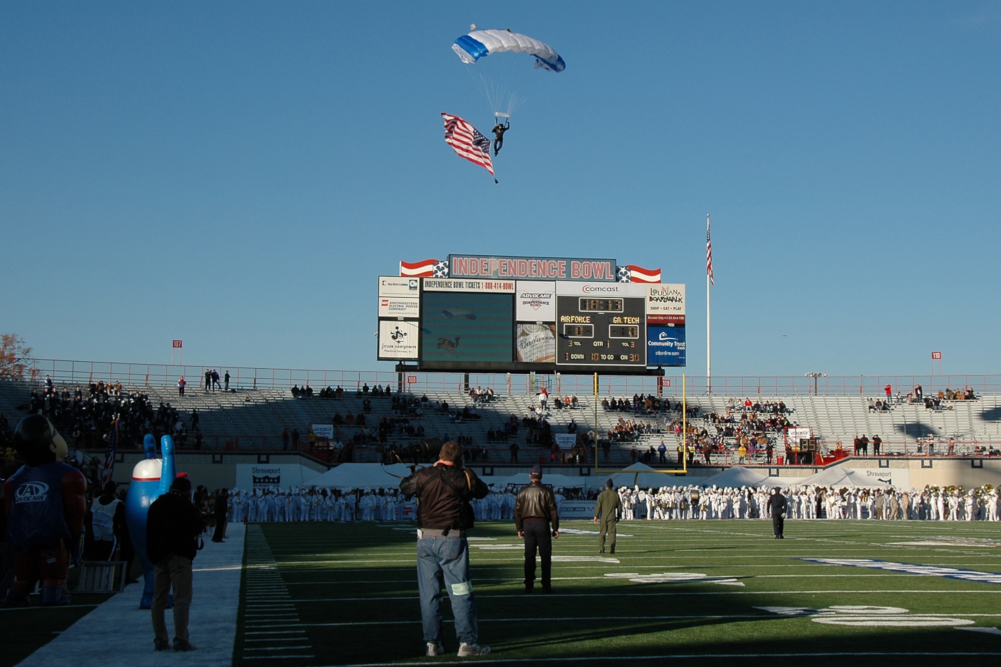 An Air Force parachutist makes a final turn to his target area with the American flag just before the kickoff of the Advocare V 100 Independence Bowl in Shreveport, La., Dec. 27, 2010. The U.S. Air Force Academy Falcons faced off against the Georgia Tech Yellow Jackets in the contest and came out with the win 14-7. (U.S. Air Force photo/ Senior Airman Kimberly Simon)     