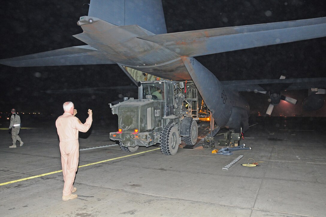 Afghanistan - SMSgt Sam Currie guides a forklift back as cargo is being unloaded  at Bagram Airfield on January 1, 2011. Six of the 165th Airlift Wing's C-130H aircraft will fly cargo missions in support of Operation Enduring Freedom.