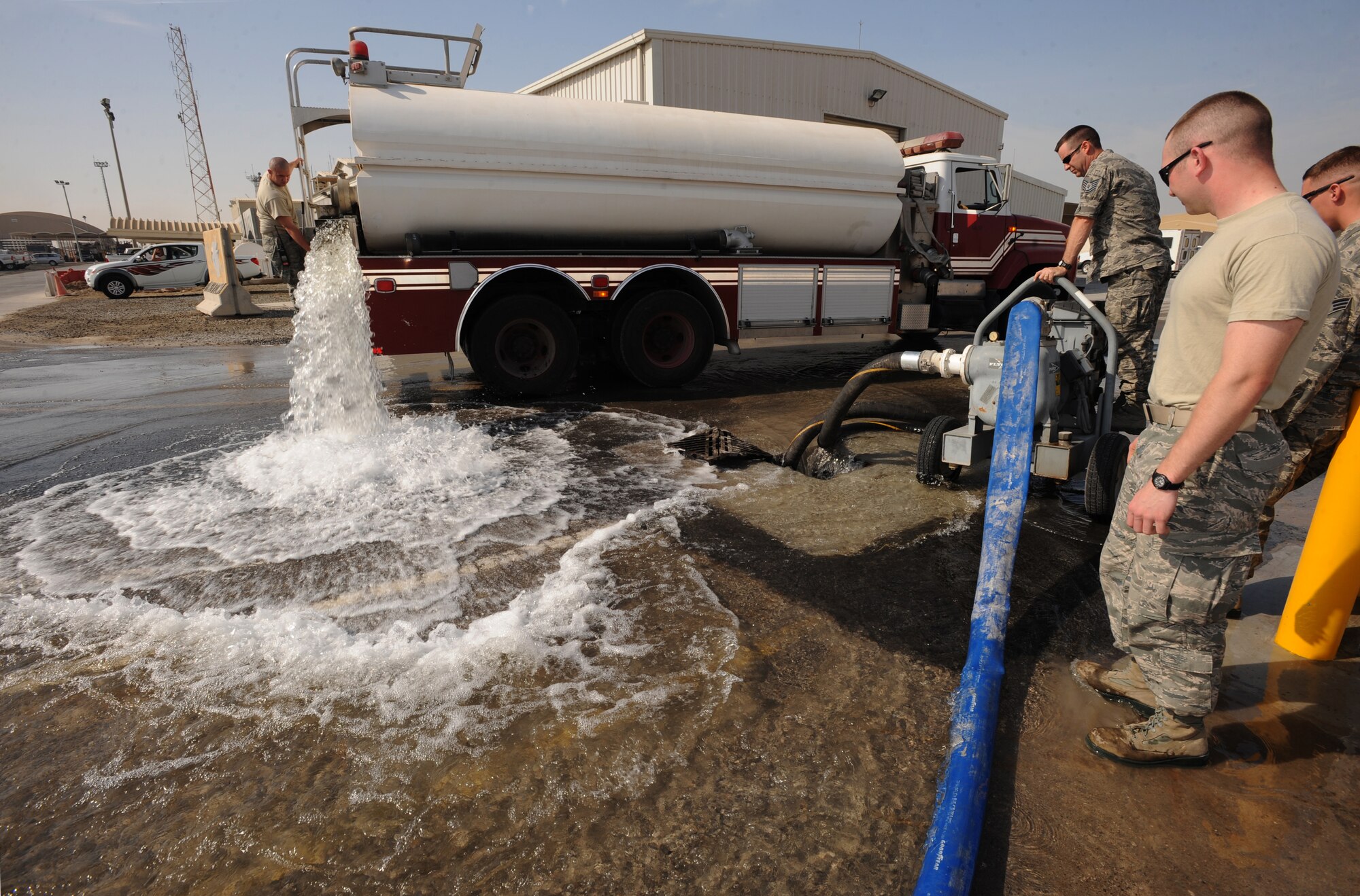 Airman 1st Class Joshua Hammers, 380th Expeditionary Civil Engineer Squadron Fire Department, releases 10,000 gallons of water Jan. 5, 2011, during a Flood Response Exercise at an undisclosed location in Southwest Asia. The FRE is used as a training tool to ensure Airmen are prepared to immediately moderate water overflow. (U.S. Air Force photo by Senior Airman Maynelinne De La Cruz)(Released) 
