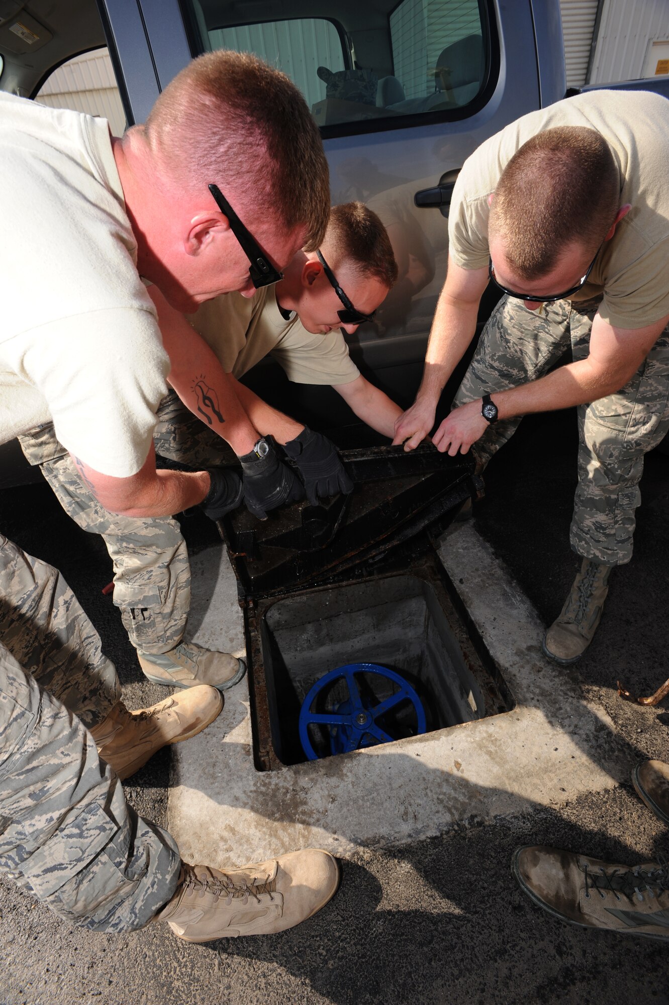 Members of the 380th Expeditionary Civil Engineer Squadron, inspect an isolation valve pit Jan. 5, 2011, during a Flood Response Exercise at an undisclosed location in Southwest Asia. The FRE is used as a training tool to ensure Airmen are prepared to immediately moderate water overflow. (U.S. Air Force photo by Senior Airman Maynelinne De La Cruz)(Released) 