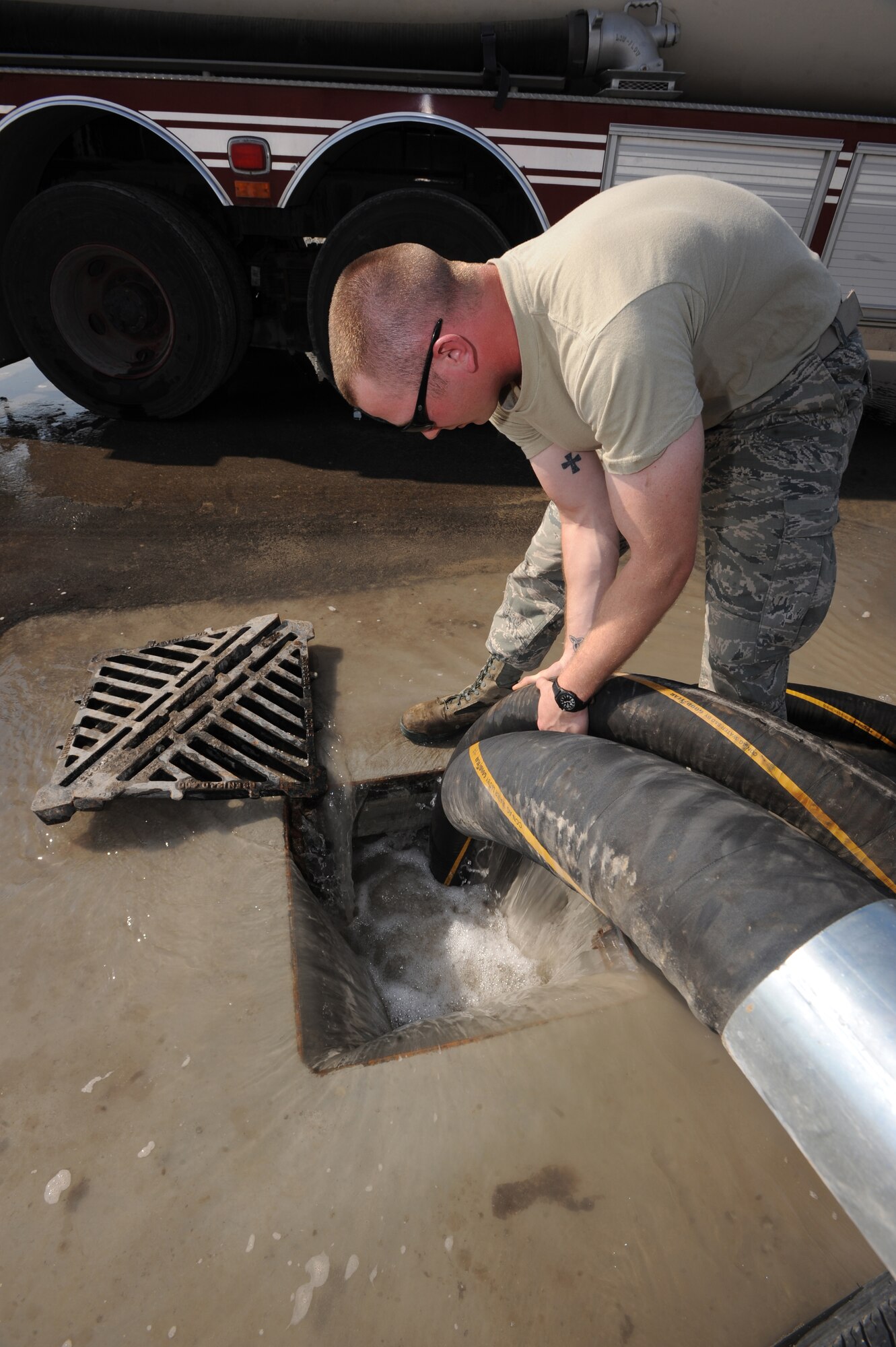 Airman 1st Class Leonard Stroud, 380th Expeditionary Civil Engineer Squadron, ensures the water drain is working properly Jan. 5, 2011, during a Flood Response Exercise at an undisclosed location in Southwest Asia. The FRE is used as a training tool to ensure Airmen are prepared to immediately moderate water overflow. (U.S. Air Force photo by Senior Airman Maynelinne De La Cruz)(Released) 