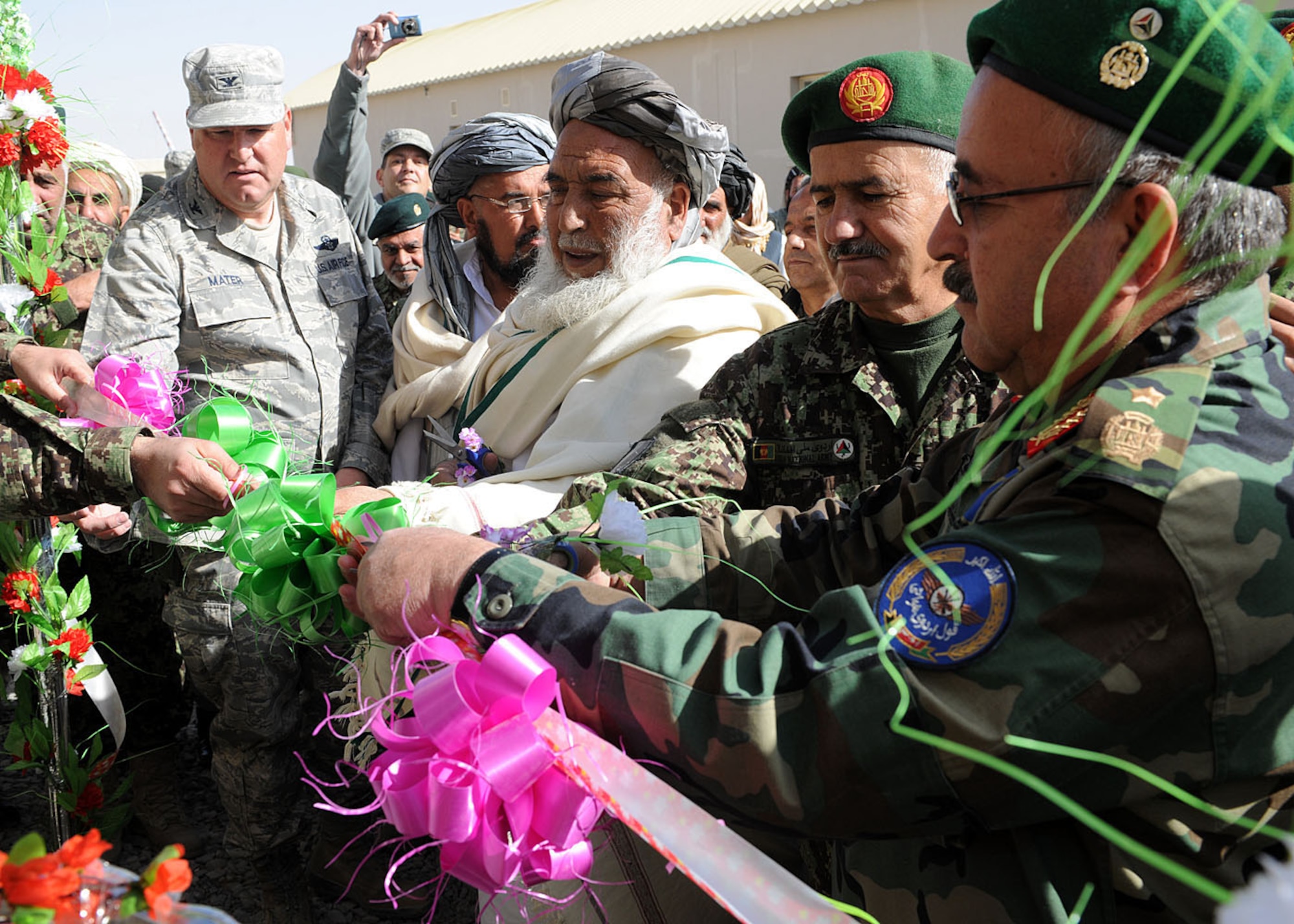 Col. Bernard Mater, 738th Air Expeditionary Advisory Group commander; Haji Nasrollah, a tribal elder from the Kandahar province; Afghan National Army Brig. Gen. Amir Baqaei, 205th Corps deputy commander; and Afghan Air Force Brig. Gen. Abdul Wahab Wardak, AAF chief of staff, cut the ribbon for the Kandahar Air Wing open house at Kandahar Airfield, Afghanistan, Jan. 1. The open house showcased the newly-constructed facilities and the Afghan and coalition aircraft inventory. The KAW, one of three air wings in Afghanistan, is an Afghan-led air power for support operations within the Afghan National Security Forces. (U.S. Air Force photo by Senior Airman Daryl Knee / 16th Mobile Public Affairs Detachment)