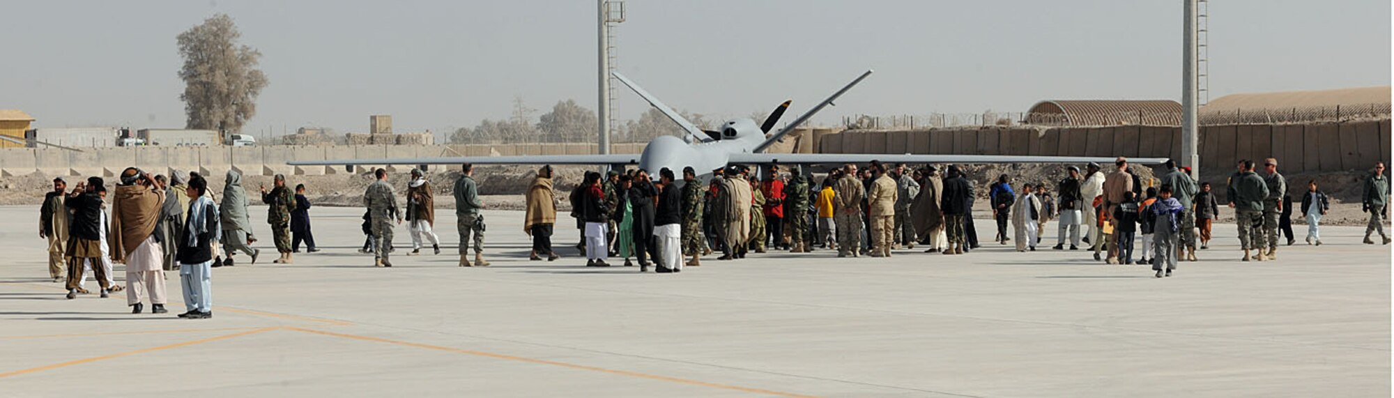 A group of Afghan tribal elders, school children and coalition forces inspect an MQ-9 Reaper at the Afghan Air Force?s Kandahar Air Wing open house at Kandahar Airfield, Afghanistan, Jan. 1. The open house showcased the newly-constructed KAW facilities and the Afghan and coalition aircraft inventory. (U.S. Air Force photo by Senior Airman Daryl Knee / 16th Mobile Public Affairs Detachment)