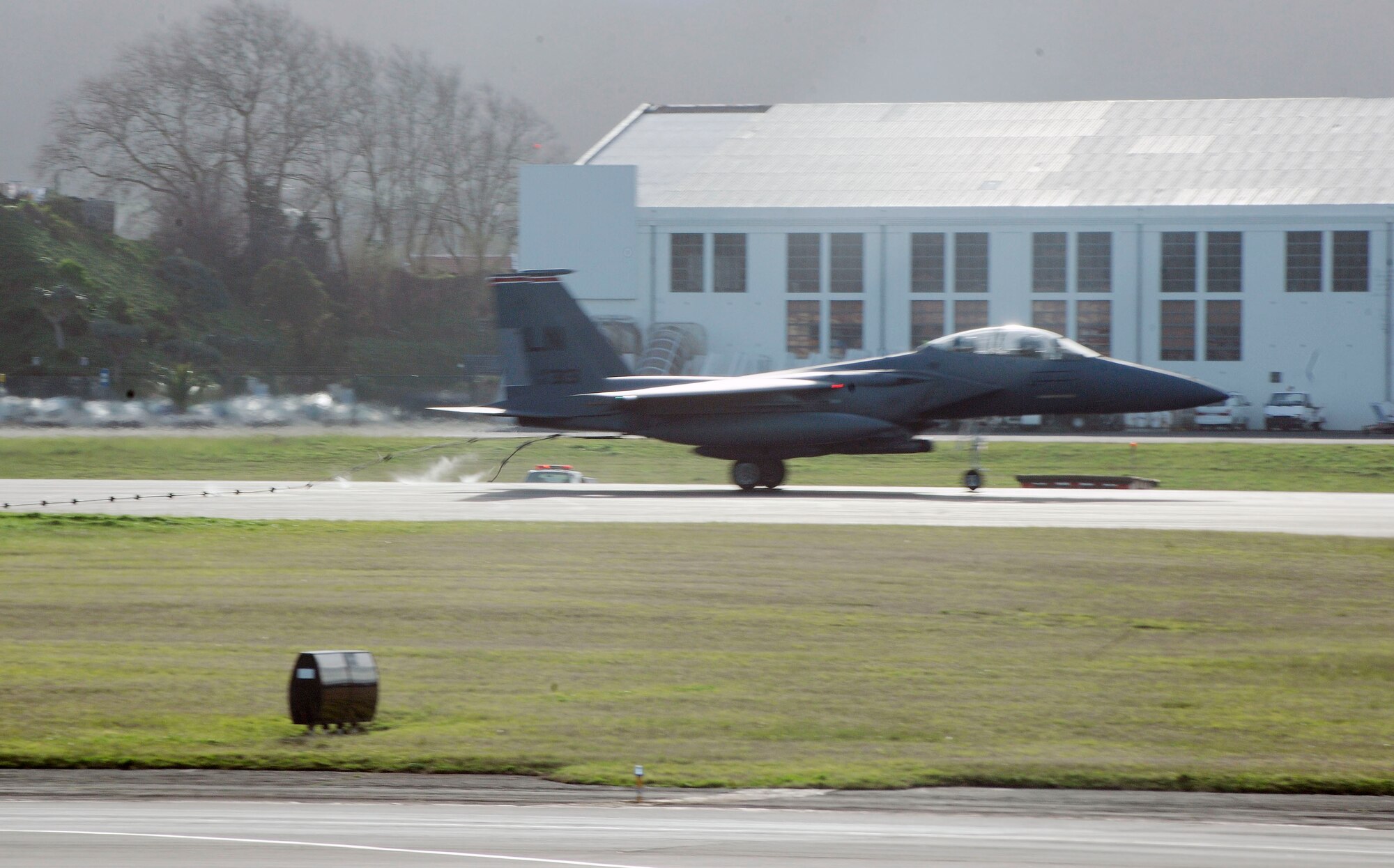 One of the two F-15s from Royal Air Force Lakenheath catches the south runway safety barrier as part of the annual barrier certification test at Lajes Field, Azores, Dec. 29. (Photo by Guido Melo)