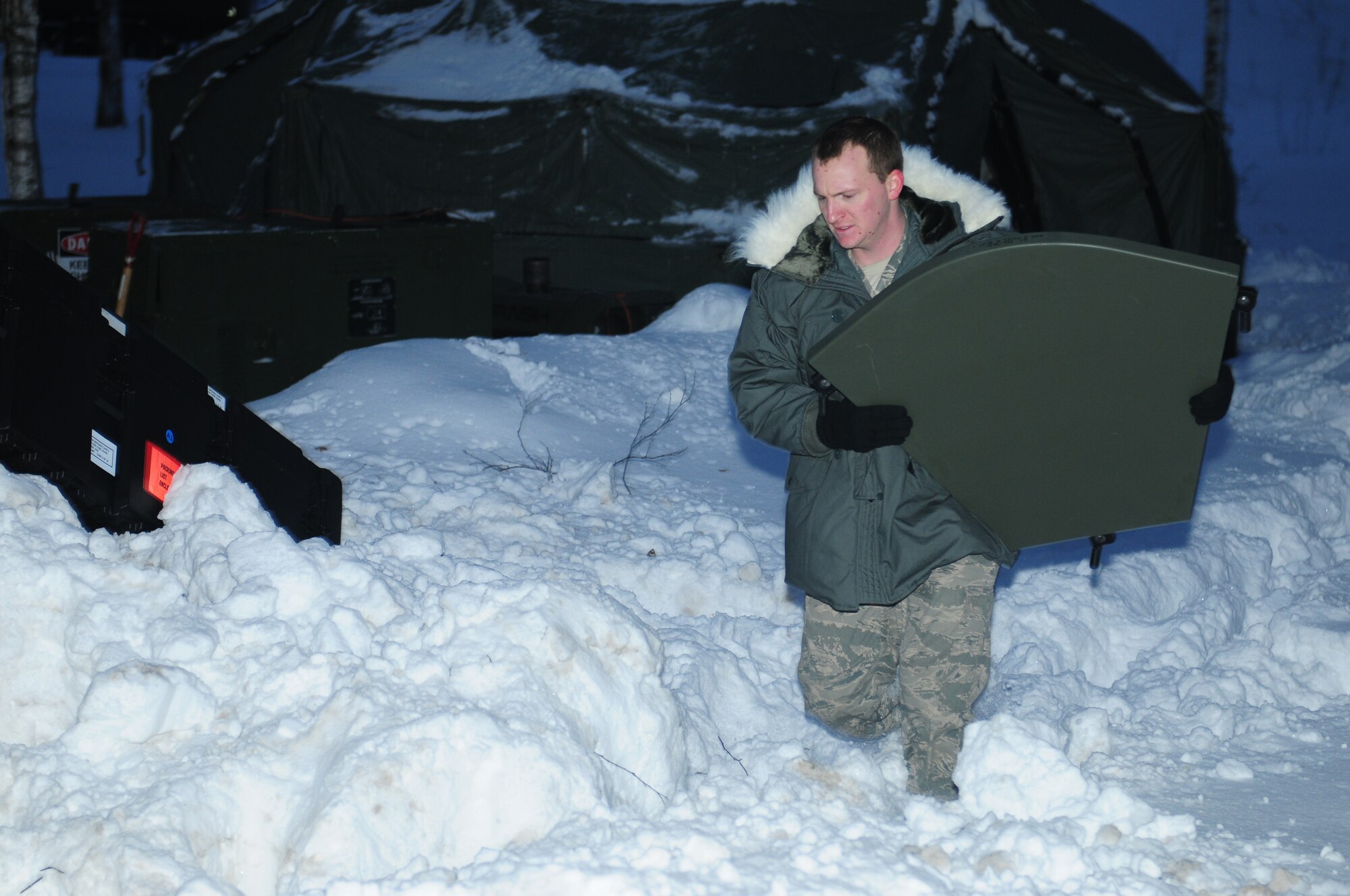 LITHUANIA AIR FORCE AIR BASE, Lithuania - Staff Sgt. Mark Pauley, a transmission systems technician for the 493rd Expeditionary Fighter Squadron, carries an antenna component through the snow after thawing it out Jan. 4. Sergeant Pauley and several other Airmen are deployed from the 1st Combat Communications Squadron at Ramstein Air Base, Germany, to provide secure and unsecure voice and data communications for the 493rd EFS in support of NATO’s Baltic air policing mission. Sergeant Pauley calls Morganfield, Ky., home. (U.S. Air Force photo/Staff Sgt. Stephen Linch)