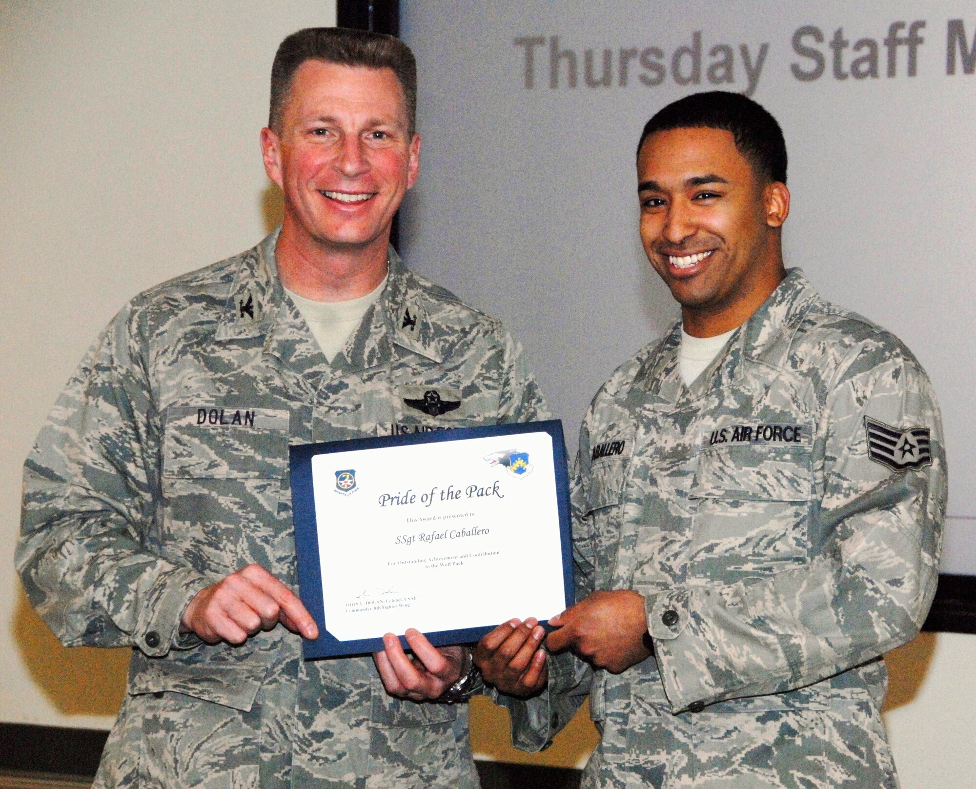 KUNSAN AIR BASE, Republic of Korea -- Col. John Dolan, 8th Fighter Wing commander, presents Staff Sgt. Rafael Caballero, 8th Operations Group, with a Pride of the Pack award Jan. 6. (U.S. Air Force photo/Capt. Sheryll Klinkel) 