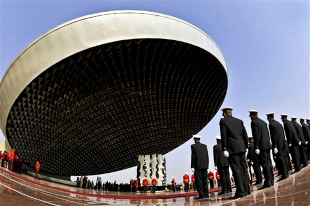 Iraqi and U.S. military members stand during a ceremony at Iraq’s tomb of the unknown soldier before the start of Iraqi Army Day parade in Baghdad, Jan. 6, 2011.