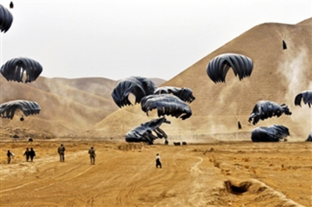 U.S. troops retrieve cargo dropped from a U.S. Air Force C-17 Globemaster III near Forward Operating Base Todd in Afghanistan's Baghdis province on Jan. 6, 2011.  The base and more than a dozen nearby combat outposts rely on U.S. and Italian airdrops for all their supplies. The C-17 air crew is from Charleston Air Force Base, S.C.  