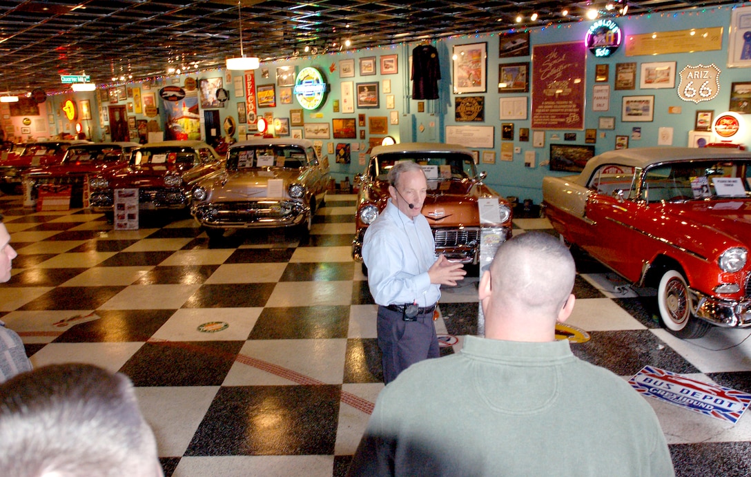 Chuck Spielman, center, president of Only Yesterday Classic Autos and Hall of Heroes, explains the history of his private auto collection to Marines and sailors from Marine Corps Recruit Depot, San Diego, during an invitational tour Jan 7.  The tour of Spielman’s private collection was an opportunity to gain a greater appreciation of 20th century Americana and learn more about military history from different perspectives.