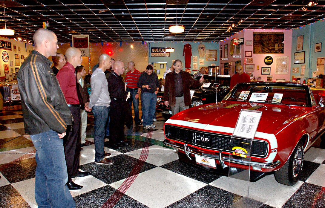Bob Rabourne, community outreach representative, Only Yesterday Classic Auto and Hall of Heroes, briefly explains the history of Spielman’s 1967 Chevrolet SS convertible to Marine Drill Instructors of Marine Corps Recruit Depot San Diego Jan. 7. The tour of Spielman’s private collection was an opportunity to gain a greater appreciation of 20th century Americana and learn more about military history from different perspectives.