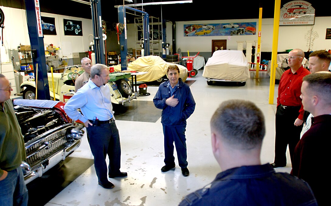 Armando Fragomeni, center, master mechanic for Only Yesterday Classic Autos and Hall of Heroes, explains how he ended up working for Spielman.  Fragomeni, once the head mechanic and test driver for Ferrari swept floors at the beginning of his employment there.  He later went on to test drive vehicles for Lamborghini, Mercedes and Maserati.