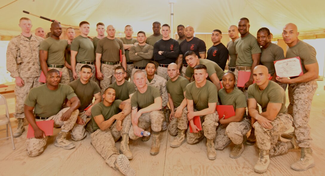 Twenty-five Marines from 1st Marine Logistics Group (Forward), along with their instructors, pose for a class photo before graduating from the 3-week Marine Corps Martial Arts Program Instructor course at Camp Leatherneck, Afghanistan, Jan. 7. Dedicating more than 160 hours to earn the title MCMAP instructor, the Marines were physically and mentally challenged with combat conditioning, strength exercises and mental assessments during the course.