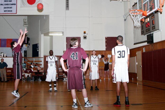 Jake Portillo, Matthew C. Perry High School Samurai center, shoots a free-throw shot during a regular season basketball game against the Camp Zama High School Trojans at the M. C. Perry High School gym here Saturday. The Samurai players managed to narrowly defeat the Trojans 50-48 and bring their record to 11-5.