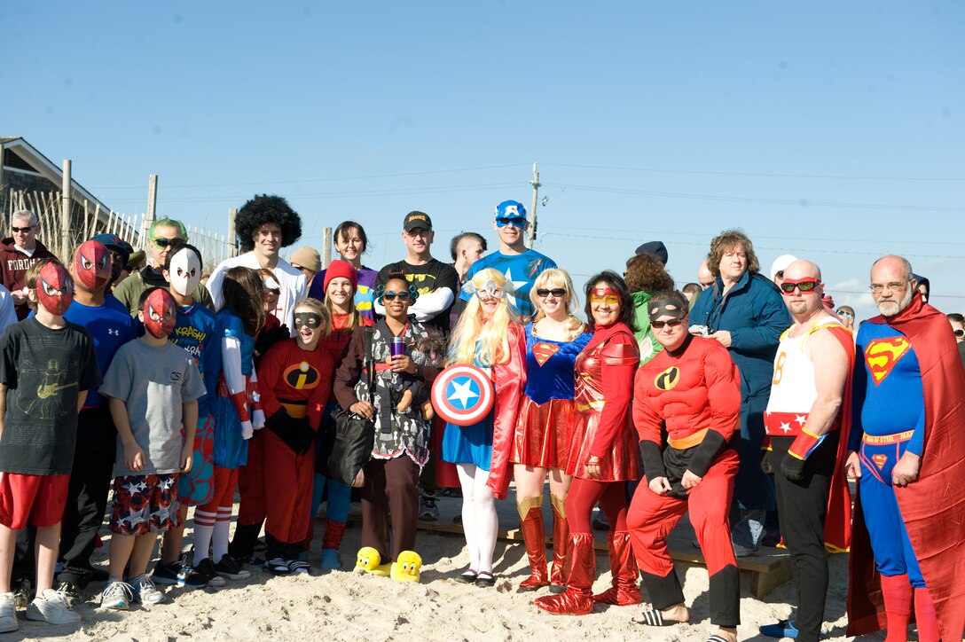The “Superheroes” from Marine Corps Air Station New River celebrate their win for the costume contest at the Special Olympics Polar Plunge at Onslow Beach, Saturday, Jan. 8, 2011.