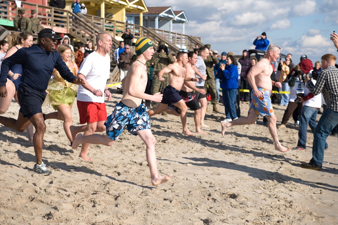 Leaders from Marine Corps Base Camp Lejeune charge into the winter waters for the Special Olympics Polar Plunge at Onslow Beach, Saturday, Jan. 8, 2011.