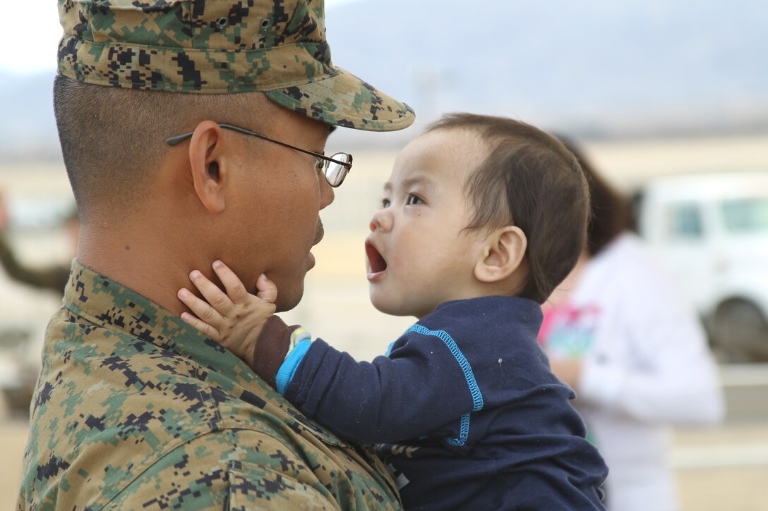Eight-month-old Aristotle Tuvera, Jr., says hello to his dad Petty Officer 1st Class Aristotle Tuvera, a corpsman with Battalion Landing Team 1st Battalion, 7th Regiment. Tuvera returned home Jan. 8 from an eight-month-long deployment.