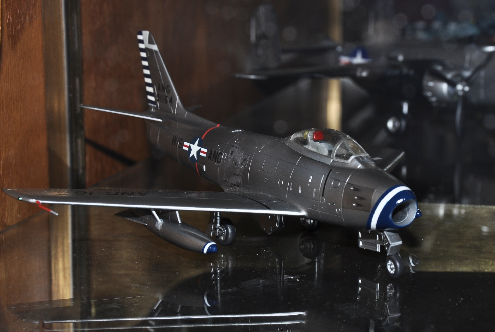 A model F-86 Sabre rests on display at the 128th Air Refueling Wing, Milwaukee, Wis.  The Sabre model was donated by the Richard I. Bong chapter of the International Plastic Model Society on Saturday, January 8, 2011, and it is a replica of an aircraft once used by the Wing.  The model is a 1/72nd depiction of the aircraft, where one inch equals six feet.  U.S. Air Force photo by Staff Sgt. Jeremy Wilson / Released