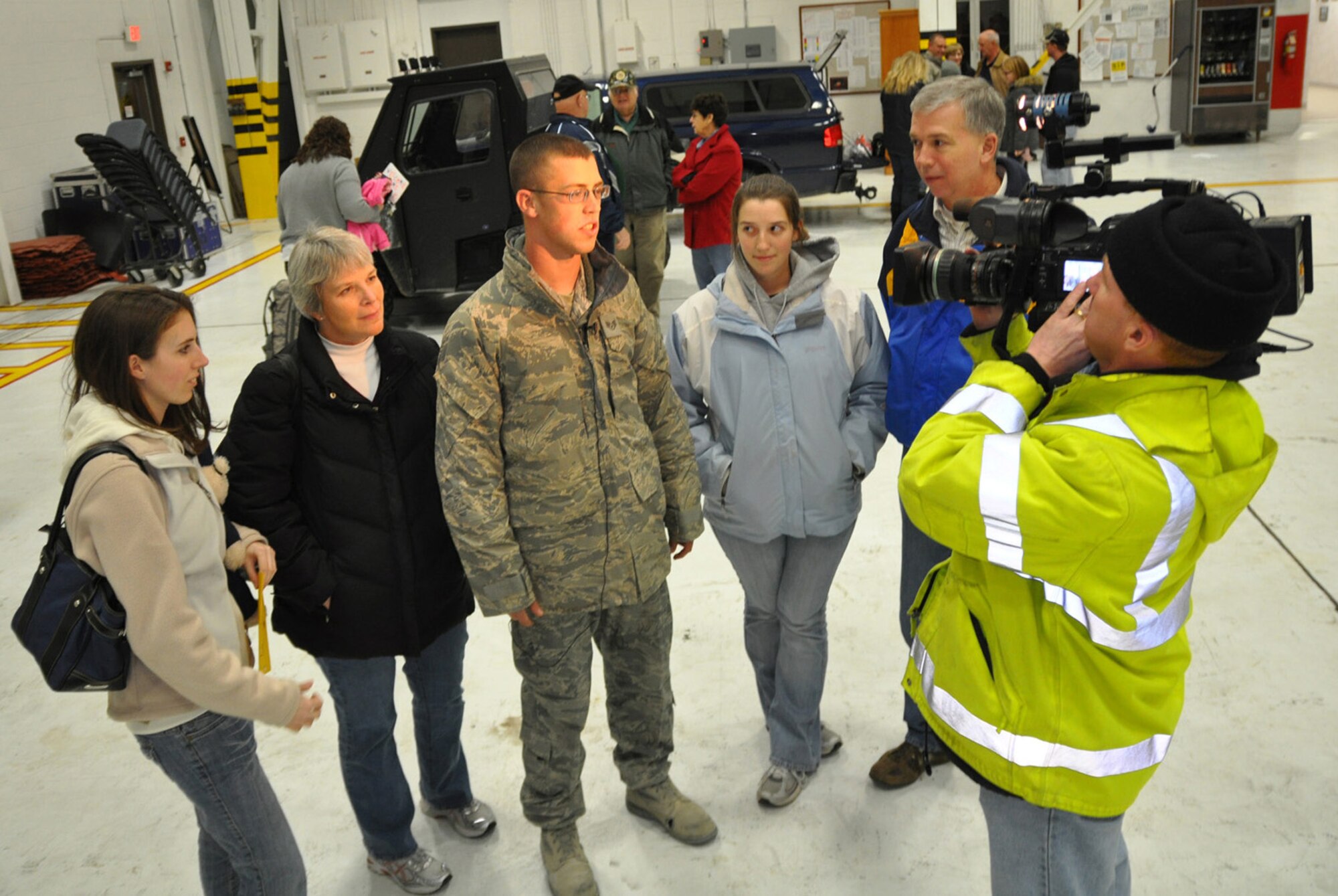 YOUNGSTOWN AIR RESERVE STATION, Ohio — Air Force Reserve Staff Sgt. Matthew Korb, a member of the 76th Aerial Port Squadron based here, is interviewed by Brian Ohlbeck, a videographer with WKBN-TV 27 just after arriving at the air station Jan. 5 from a deployment to Afghanistan.  He and 16 others deployed to Kandhahar Airfield for up to 180 days providing personnel support traffic management services, passenger/cargo movement on airlift missions maintaining a global deployment capability. U.S. Air Force photo by Major Brent Davis