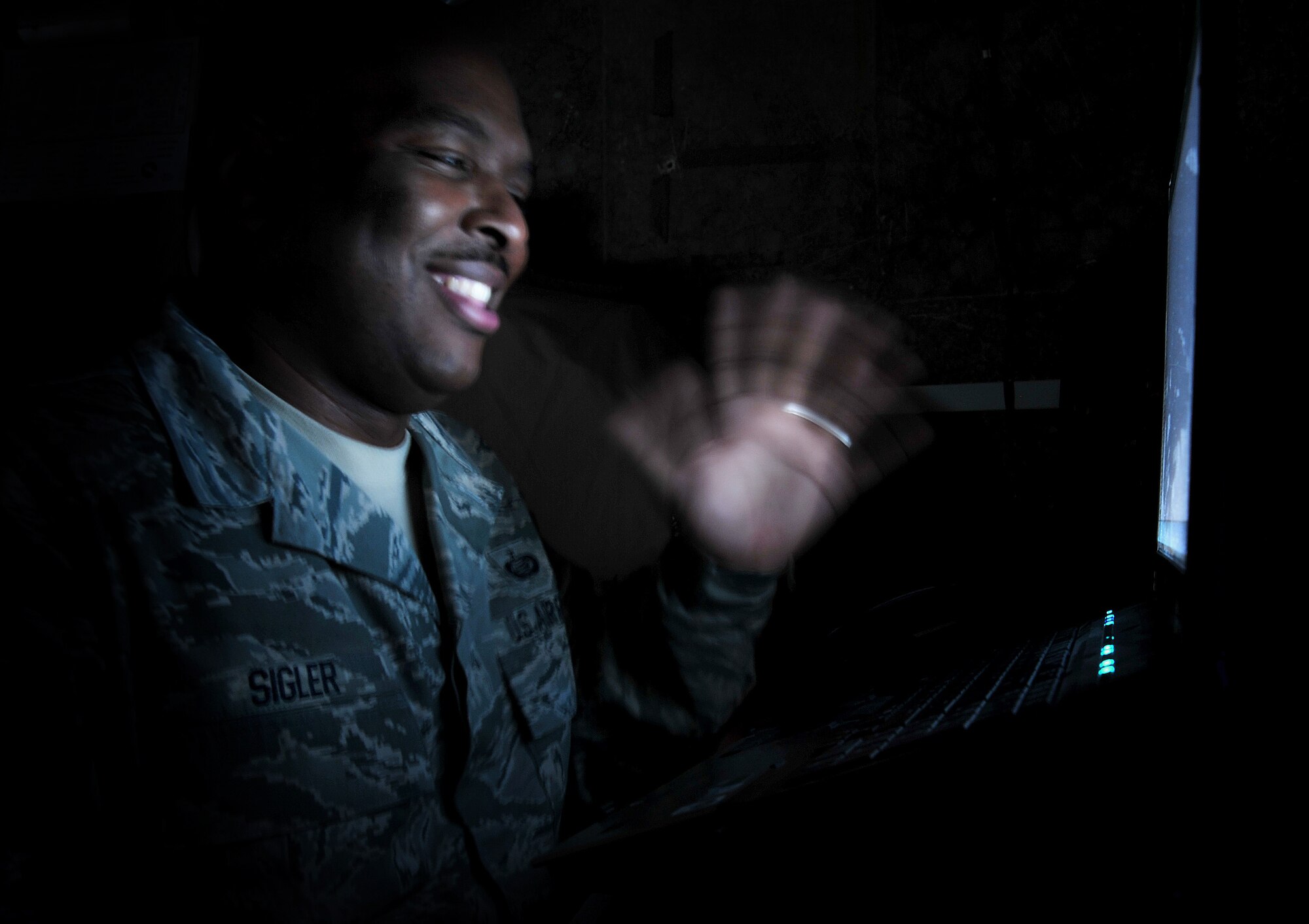 Master Sgt. David Sigler waves to the webcam, Jan. 4, on Camp Victory, Iraq. Sergeant Sigler keeps in touch with his family by phone or Skype. (U.S. Air Force photo by Senior Airman Andrew Lee)