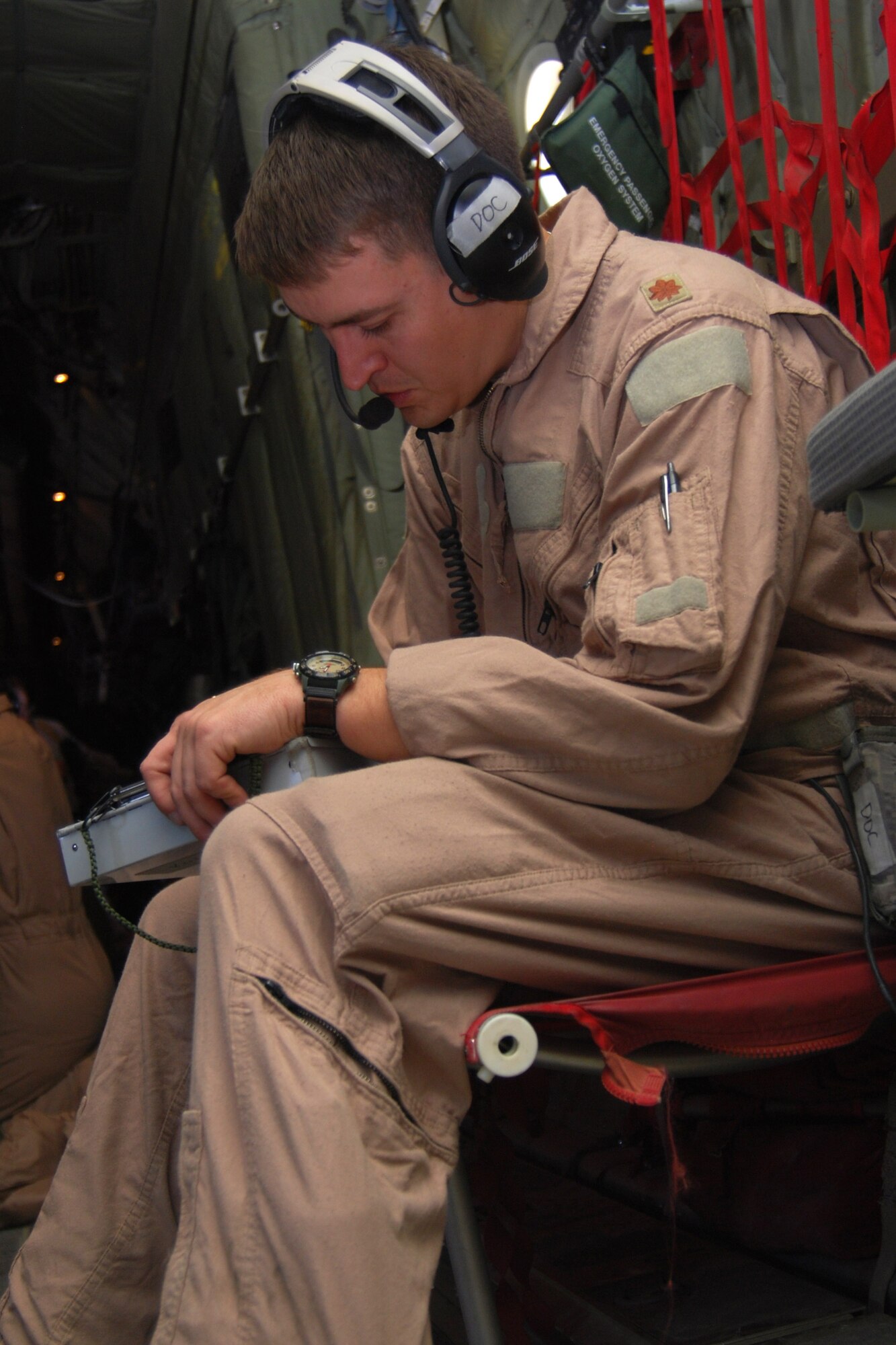 Maj. (Dr.) George Kotti makes notes on a patient?s medical chart inside a C-130H-Hercules Jan. 5, 2011. The critical care air transport team is a specialized three-person team that recreates an intensive care unit environment within an aircraft during aeromedical evacuations. Dr. Kotti is a 451st Aeromedical Evacuation Squadron CCATT clinical doctor deployed from Keesler Air Force Base, Miss. (U.S. Air Force photo by Senior Airman Melissa B. White/Released)