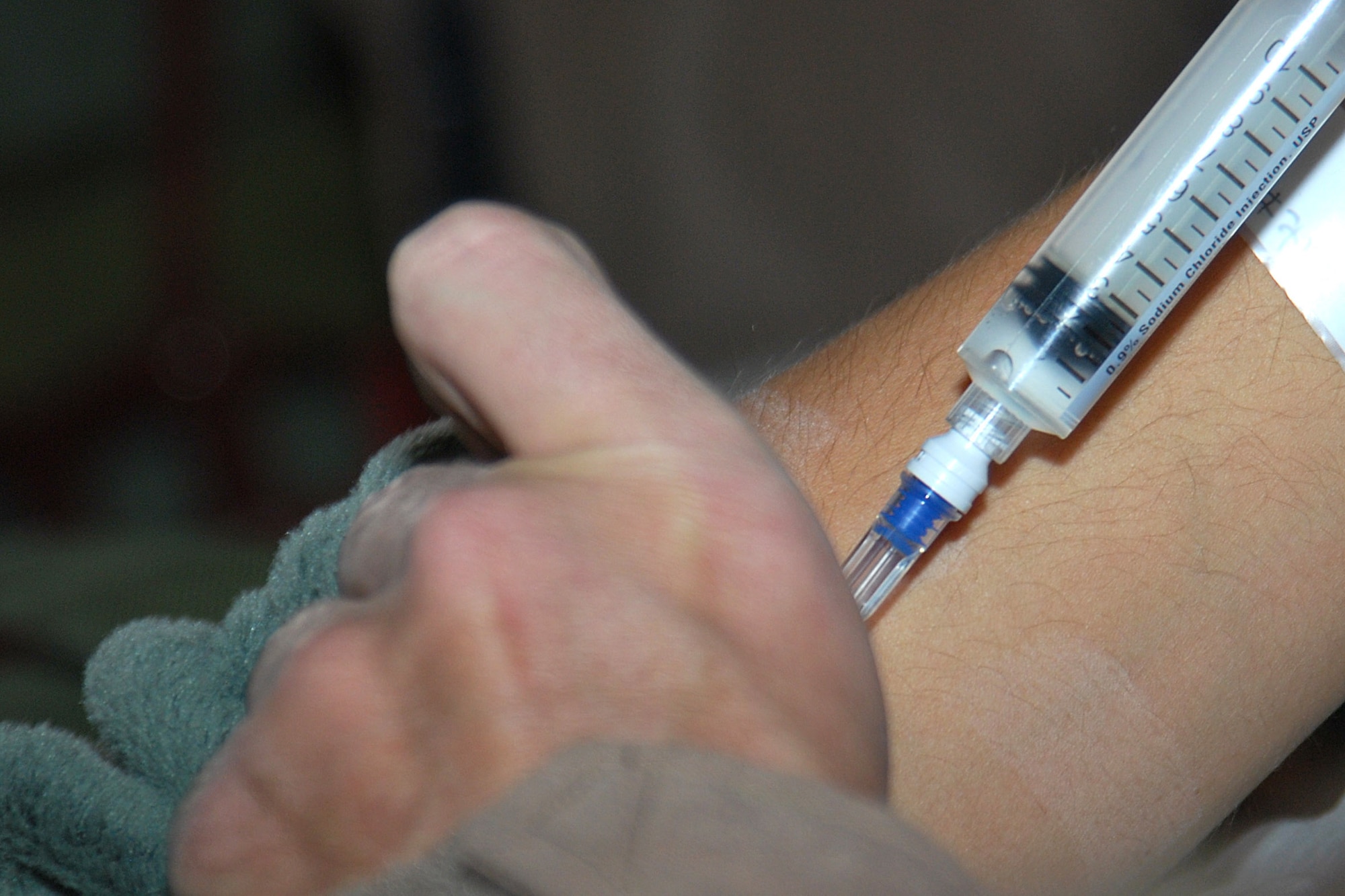 Master Sgt. Rich Pakula flushes a patient?s IV aboard a C-130H Hercules Jan. 5, 2011, at Kandahar Airfield, Afghanistan. The critical care air transport team is a specialized three-person team that recreates an intensive care unit environment within an aircraft during aeromedical evacuations. Sergeant Pakula is a 451st Expeditionary Aeromedical Evacuation Squadron CCATT respiratory technician deployed from Keesler Air Force Base, Miss. (U.S. Air Force photo by Senior Airman Melissa B. White/Released)