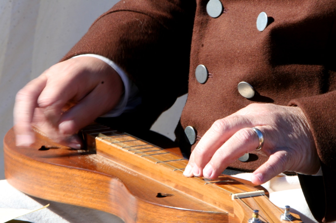 An American civilian role player strums a dulcimer in the American camp.  The Jean Lafitte National Historic Park and Preserve hosted a series of living history events on the Chalmette Battlefield in Chalmette, La., Jan. 7-8 in remembrance of the 1815 Battle of New Orleans.  (Official Marine Corps photo by Cpl. Jad Sleiman)