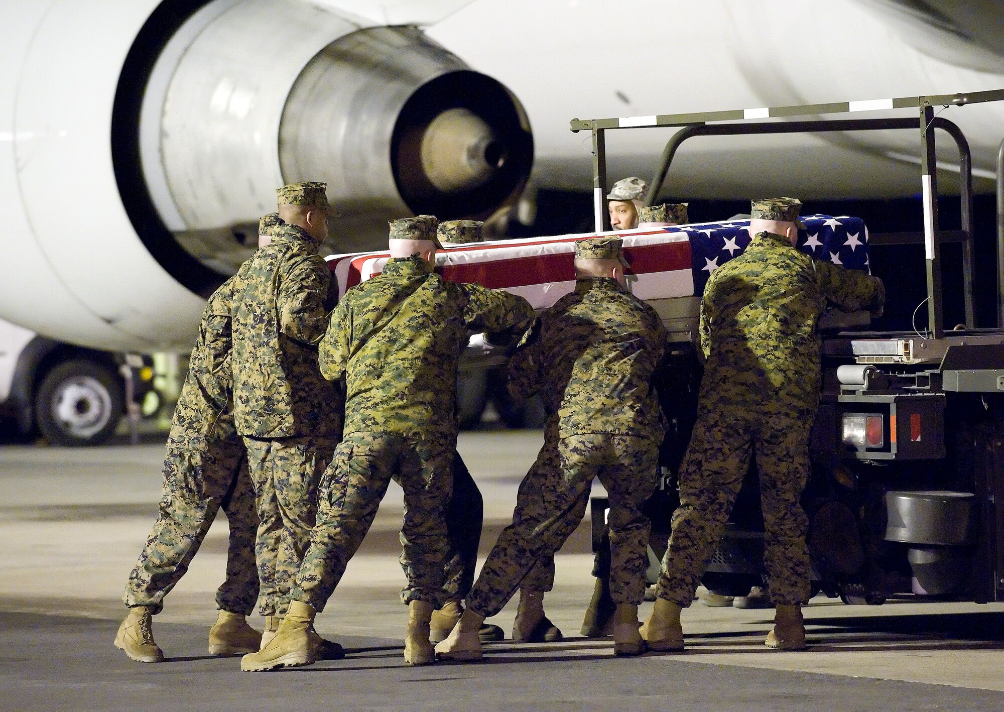 A U.S. Marine Corps carry team transfers the remains of Marine Lance Cpl. Joseph R. Giese of Winder, Ga., at Dover Air Force Base, Del., Jan. 9, 2011.  Giese was assigned to the 2nd Battalion, 9th Marine Regiment, 2nd Marine Division, II Marine Expeditionary Force, Camp Lejeune, N.C.  (U.S. Air Force photo/Jason Minto)