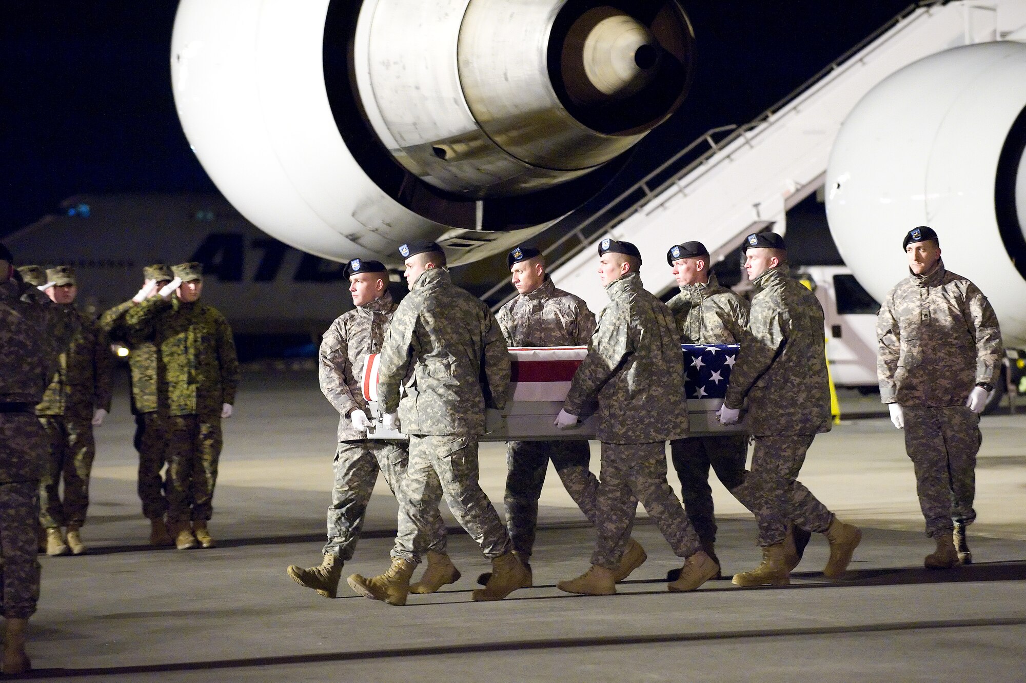 A U.S. Army carry team transfers the remains of Army Pfc. Ira B. Laningham IV of Zapata, Texas, at Dover Air Force Base, Del., Jan. 9, 2011.  Laningham was assigned to the 2nd Battalion, 30th Infantry Regiment, 4th Brigade Combat Team, 10th Mountain Division, Fort Polk, La.  (U.S. Air Force photo/Jason Minto)