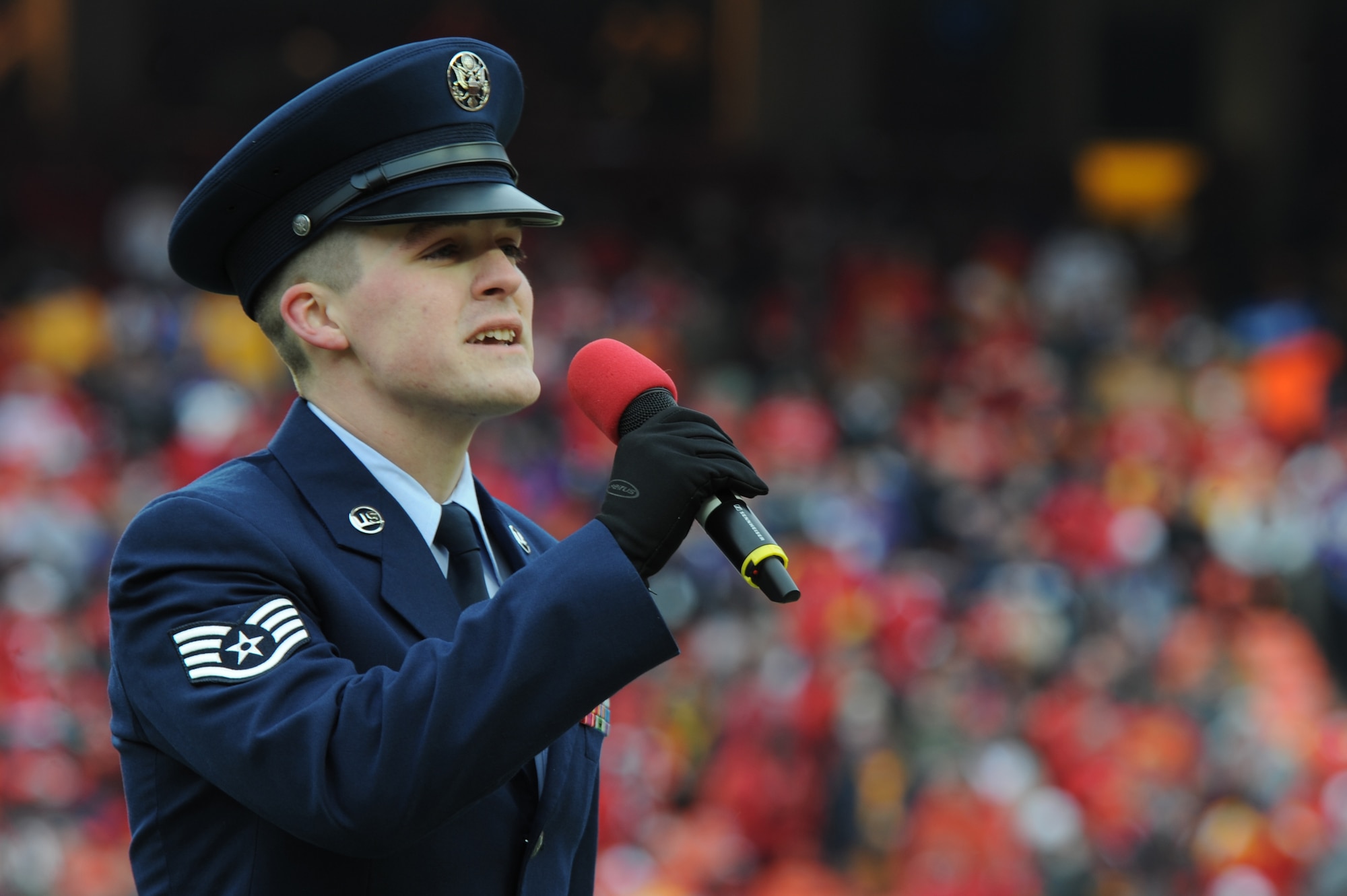 KANSAS CITY, Mo. - Staff Sgt. Nathan Tawbush, 19th Munitions Squadron weapons maintenance team chief, sings 'God Bless America' during the half-time show of the Kansas City Chief's Wild Card game against the Baltimore Ravens Jan 9. The Chiefs lost to the Ravens 30-7. (U.S. Air Force photo by Senior Airman Carlin Leslie)

