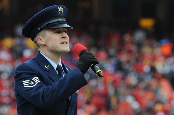 KANSAS CITY, Mo. - Staff Sgt. Nathan Tawbush, 19th Munitions Squadron weapons maintenance team chief, sings 'God Bless America' during the half-time show of the Kansas City Chief's Wild Card game against the Baltimore Ravens Jan 9. The Chiefs lost to the Ravens 30-7. (U.S. Air Force photo by Senior Airman Carlin Leslie)

