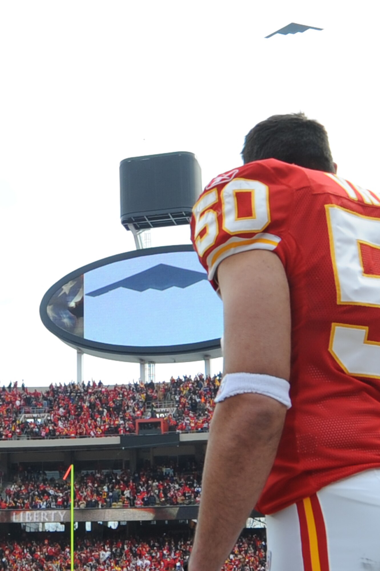 KANSAS CITY, Mo. - Mike Vrable, linebacker for the Kansas City Chiefs, takes the field as a B-2 stealth bomber from the 509th Bomb Wing flies overhead during the opening ceremonies of the Kansas City Chief’s Wild Card play-off game Jan 9. (U.S. Air Force photo by Senior Airman Carlin Leslie)