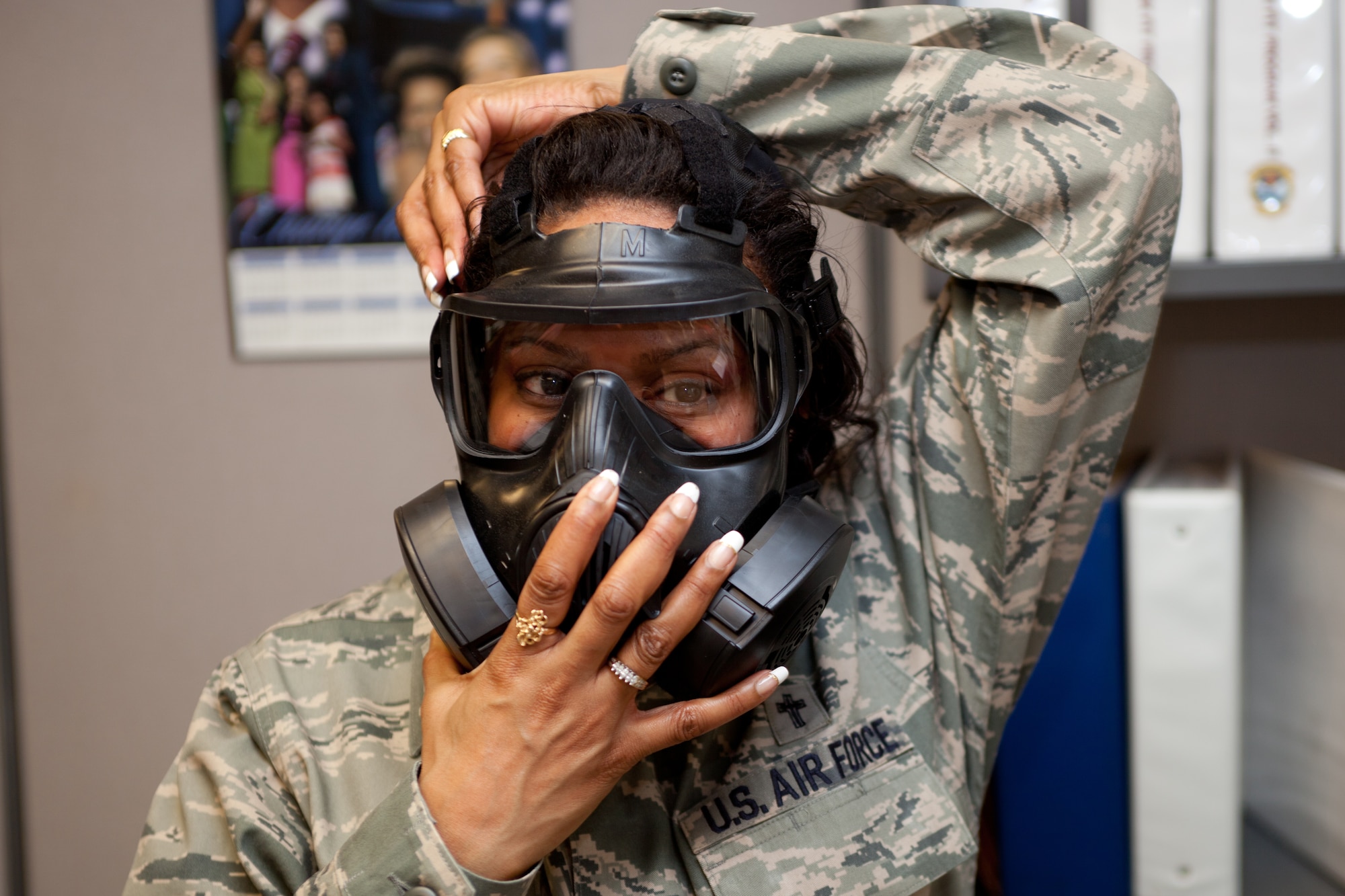 Chaplin (Major) Myrtle Bowen insures there is a good seal of her mask during a gas mask fit test. The D.C.  Air National Guard is replacing all MCU-2 A/P gas masks with the new M50 gas mask. The new M50 gas mask has twin conformal filters, which allow 50 percent improvement in breathing resistance, and allows for over 24 hours of protection against chemical or biological agents and radioactive particulate matter. (U.S. Air Force Photo by Tech Sgt. Gareth Buckland)