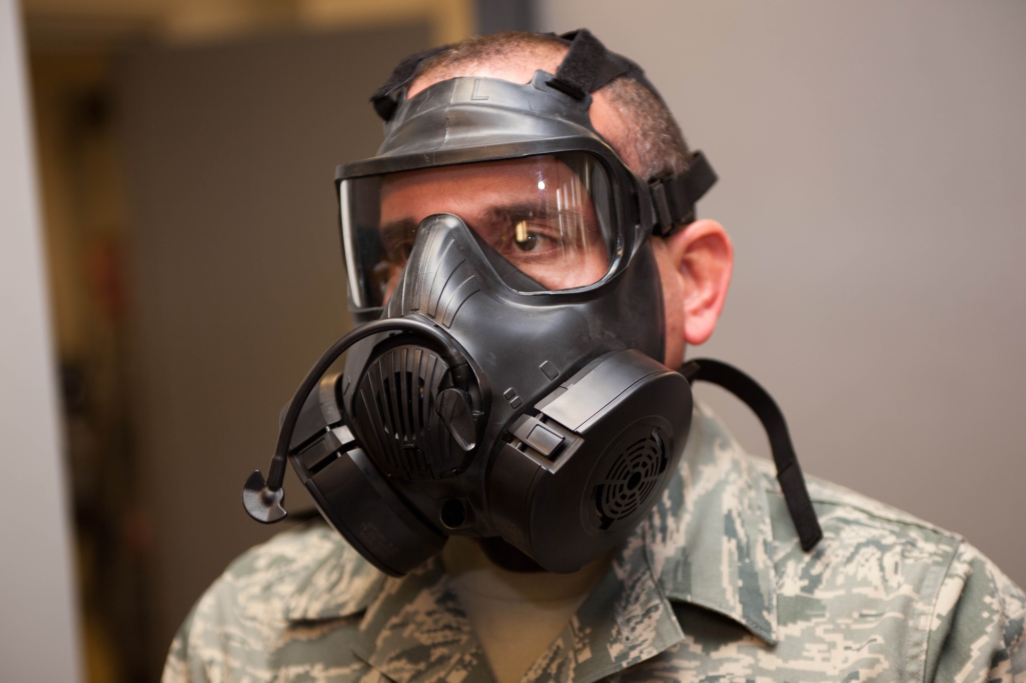 A1C Joel Cruzmarcano prepares to take a gas mask fit test. The D.C.  Air National Guard is replacing all MCU-2 A/P gas masks with the new M50 gas mask. The new M50 gas mask has twin conformal filters, which allow 50 percent improvement in breathing resistance, and allows for over 24 hours of protection against chemical or biological agents and radioactive particulate matter. (U.S. Air Force Photo by Tech Sgt. Gareth Buckland)