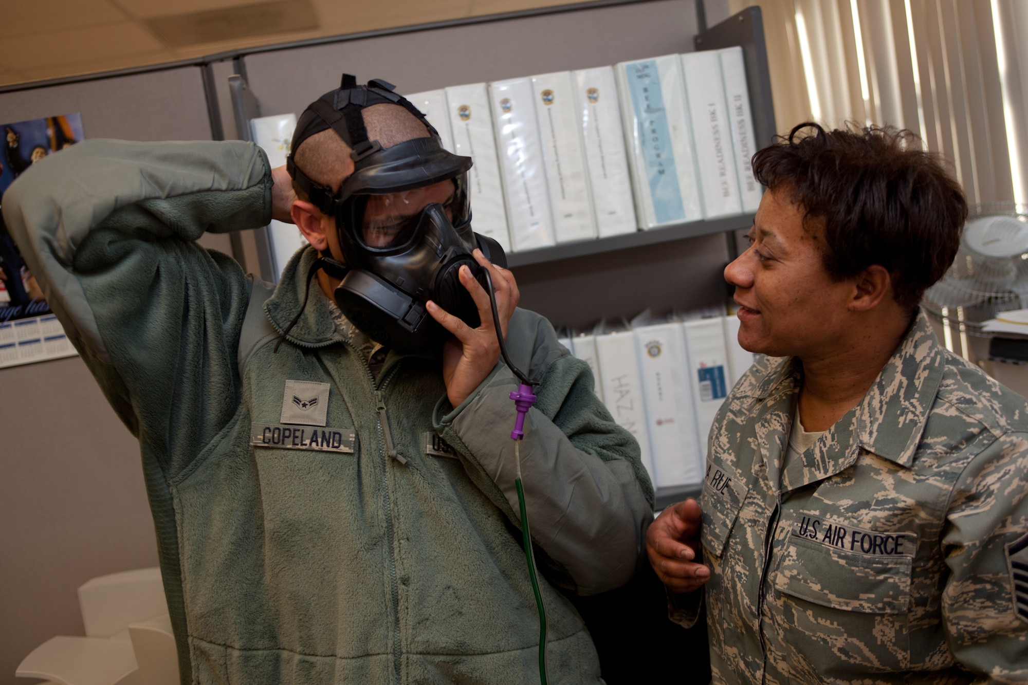 MSgt. Ollie La Rue inspects A1C Carl Copeland’s gas mask during a gas mask fit test. The D.C. Air National Guard is replacing all MCU-2 A/P gas masks with the new M50 gas mask. The new M50 gas mask has twin conformal filters, which allow 50 percent improvement in breathing resistance, and allows for over 24 hours of protection against chemical or biological agents and radioactive particulate matter. (U.S. Air Force Photo by Tech Sgt. Gareth Buckland)