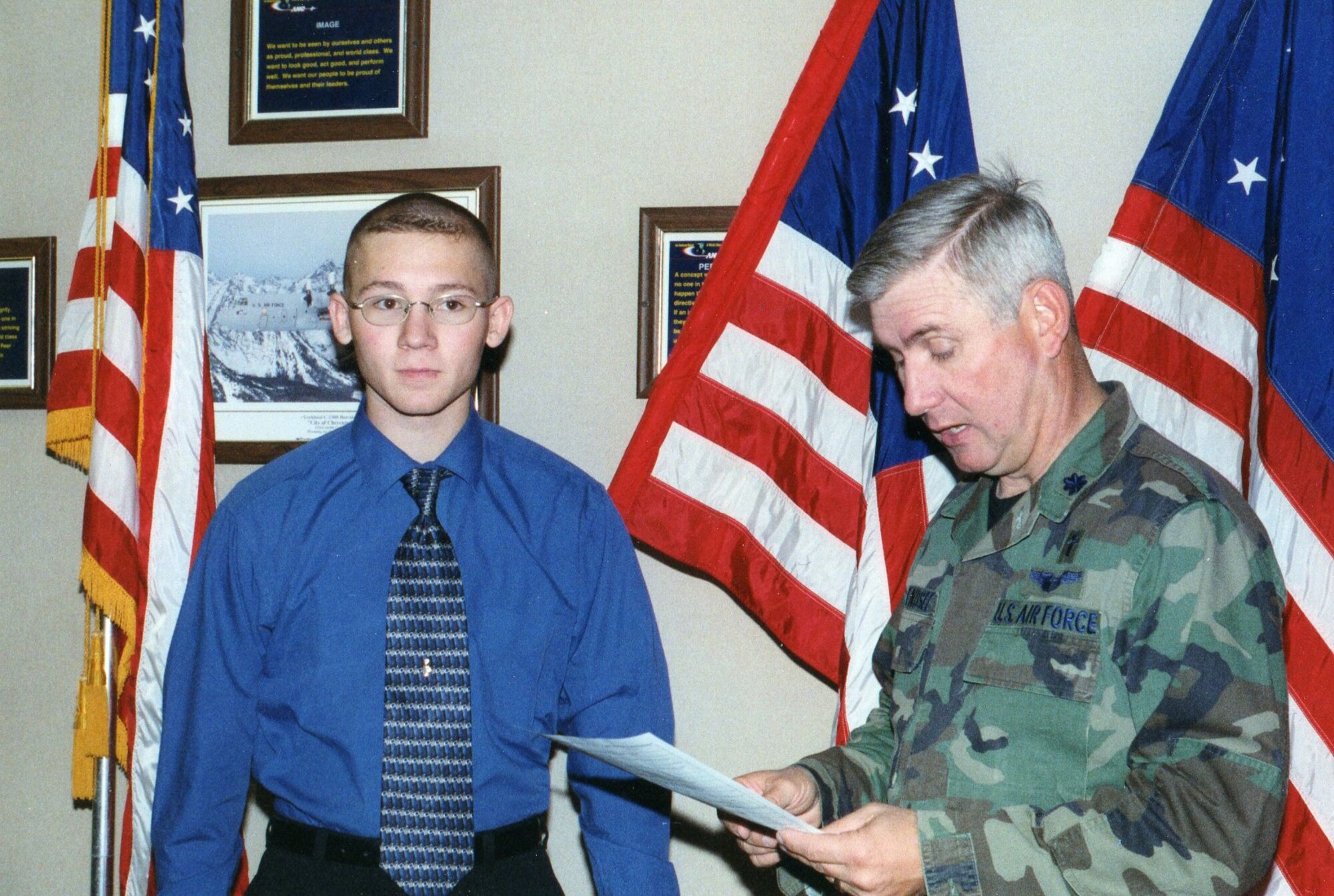 Ch. (Lt. Col.) Douglas Arendsee, 153rd Airlift Wing, wing chaplain, prepares to give the oath of enlistement to Rusty Ridley of Laramie, Wyo. Ridley, a senior in high school, is joining the 153rd Airlift Wing as a chaplain assistant.