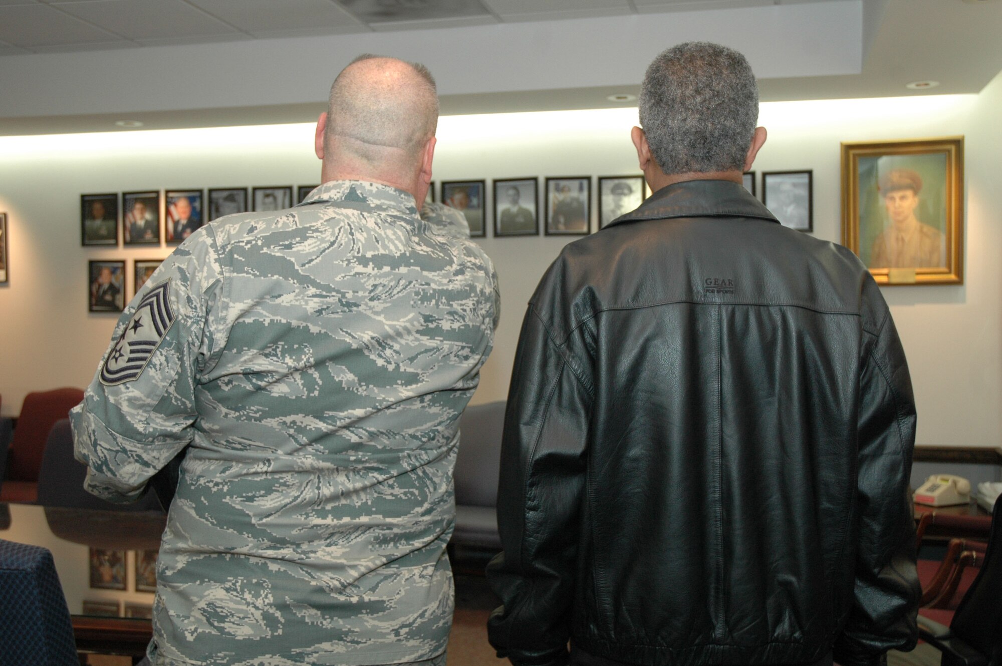Former Air Force Reserve Command Command Chief Jackson A. Winsett met with Command Chief Anderson of the 94th AW. Chief Anderson showed Chief Jackson a wall of history displayed in one of the conference rooms. (U.S. Air Force photo/ Senior Airman Danielle Campbell)